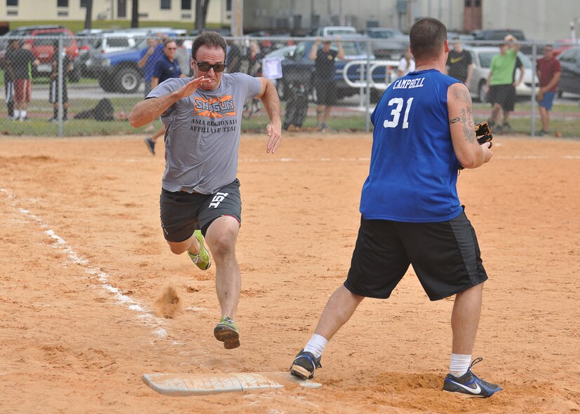 A Tyndall Airman runs to first-base Oct. 21 at Tyndall Heritage Park to beat out a throw, but falls short for an out. Airmen from various units participated in events like softball and kayaking during the base-wide Comprehensive Airmen’s Fitness day. (U.S. Air Force photo by Airman 1st Class Sergio A. Gamboa)
