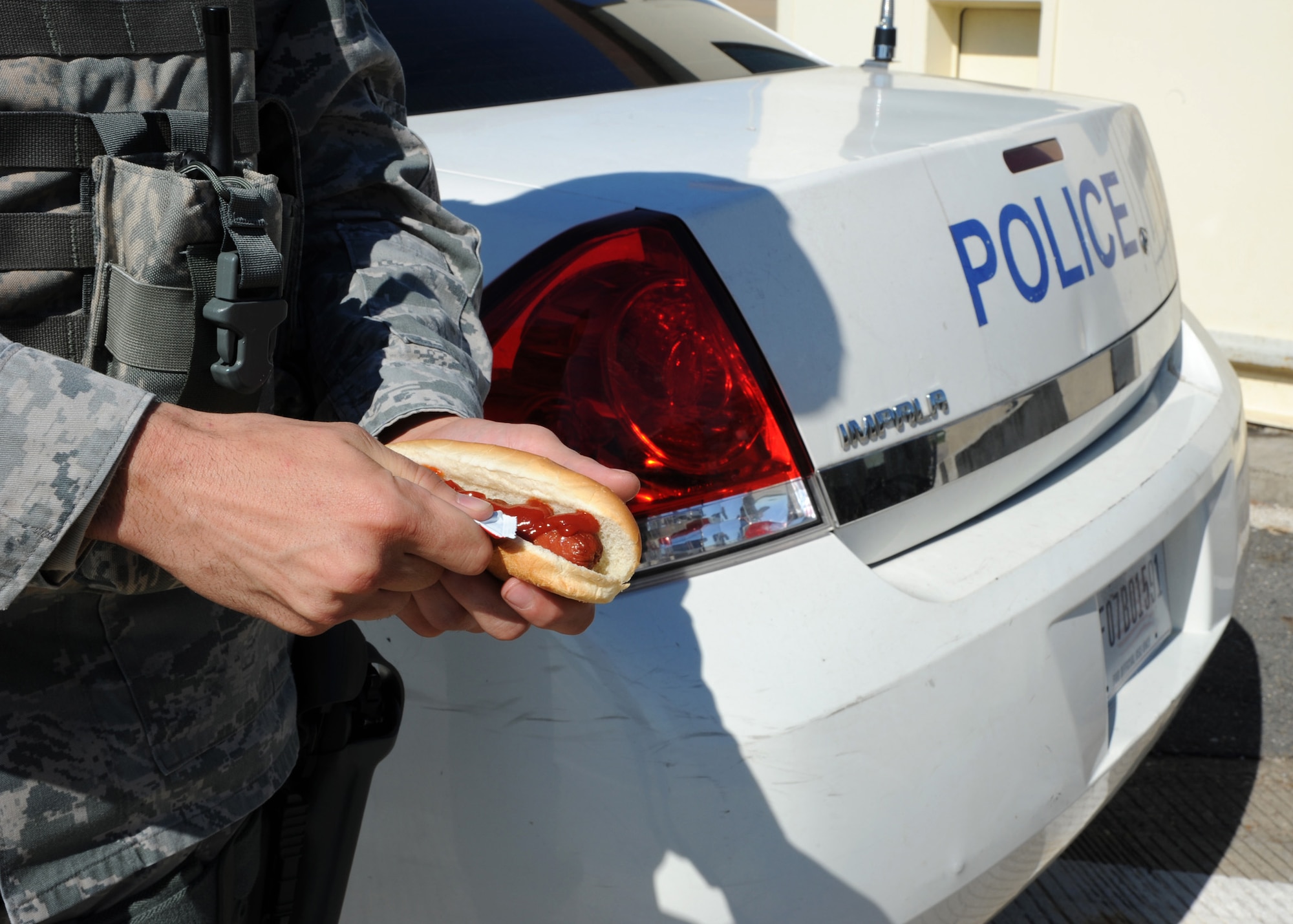 An Airman from the 2nd Security Forces Squadron puts ketchup on a hotdog on Barksdale Air Force Base, La., Oct. 25, 2013. Organizations from Barksdale and the local community donated to the cookie drive to help fuel Airmen working extended hours. (U.S. Air Force photo/Senior Airman Joseph A. Pagán Jr.)