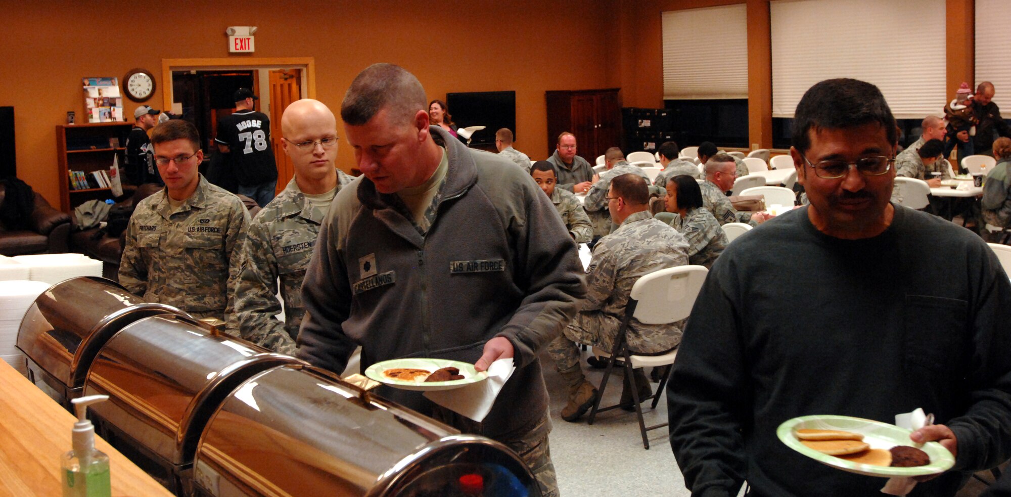 Guests serve themselves at the Pancake Breakfast and Flag Auction hosted by the Grand Forks Air Force Base First Sergeants’ Council Oct. 25, 2013, at the Prairie Rose Chapel’s Sven’s Den on Grand Forks Air Force Base, N.D. Proceeds from the event will benefit the upcoming 2013 Annual Awards Ceremony. (U.S. Air Force photo/Staff Sgt. Susan L. Davis)