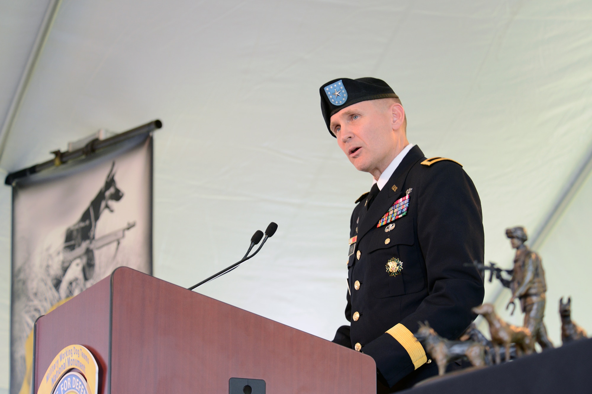 Brig. Gen. John Poppe Chief, U.S. Army Veterinary Corps, speaks at the U.S. Military Working Dog Teams National Monument dedication ceremony Oct. 28 at Joint Base San Antonio-Lackland. JBSA-Lackland is the home to the Department of Defense Military Working Dog Program and is where the U.S. Armed Forces has been training its military working dog teams since 1958. It is the world’s largest training center for military dogs and handlers and is also home to the largest veterinary hospital for military working dogs.(U.S. Air Force photo by Ben faske) (released)