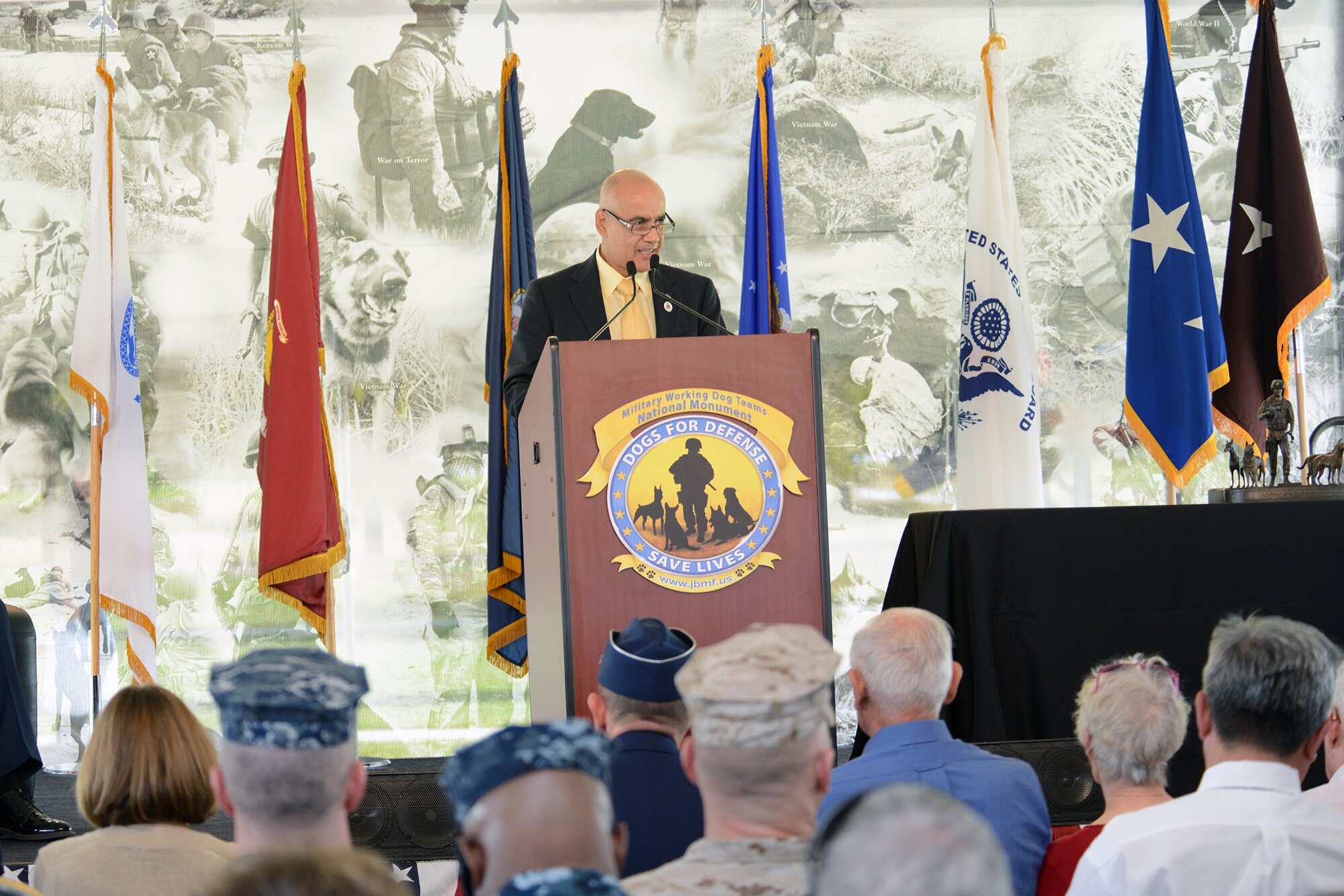 John C. Burnam Founder of the U.S. Military Working Dog Teams National Monument, speaks at the U.S. Military Working Dog Teams National Monument dedication ceremony Oct. 28 at Joint Base San Antonio-Lackland. JBSA-Lackland is the home to the Department of Defense Military Working Dog Program and is where the U.S. Armed Forces has been training its military working dog teams since 1958. It is the world’s largest training center for military dogs and handlers and is also home to the largest veterinary hospital for military working dogs.(U.S. Air Force photo by Ben faske) (released)