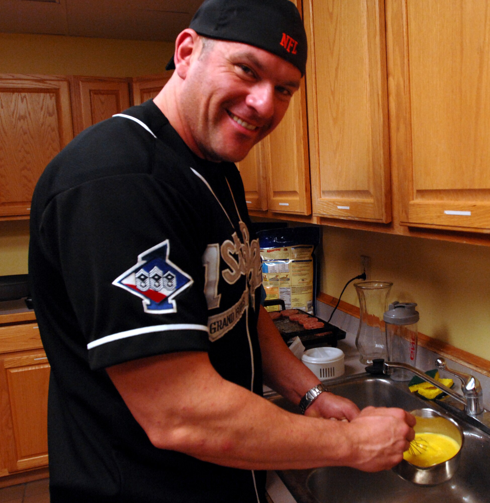 Master Sgt. Luis Vela, 319th Force Support Squadron first sergeant, scrambles eggs at the Pancake Breakfast and Flag Auction Oct. 25, 2013, at the Prairie Rose Chapel’s Sven’s Den on Grand Forks Air Force Base, N.D. Proceeds from the event will benefit the upcoming 2013 Annual Awards Ceremony. (U.S. Air Force photo/Staff Sgt. Susan L. Davis)