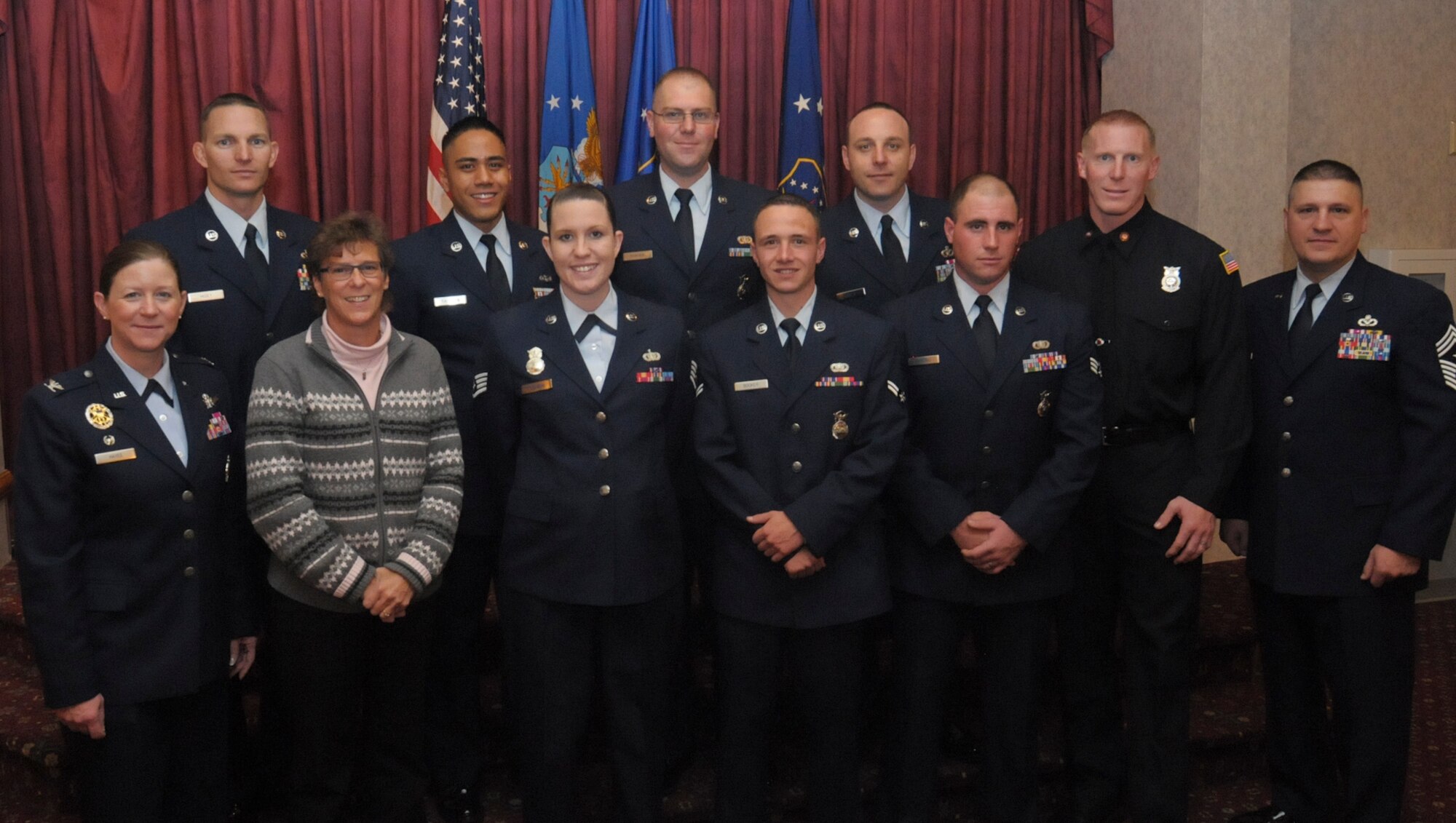 Ninetieth Missile Wing third quarter award winners pose with Col. Tracey Hayes, 90th MW commander, and Chief Master Sgt. Michael Garrou, 90th MW command chief, after an award ceremony during which they were announced as winners Oct. 25 in the Trail’s End Club. (U.S. Air Force photo by Airman 1st Class Jason Wiese)