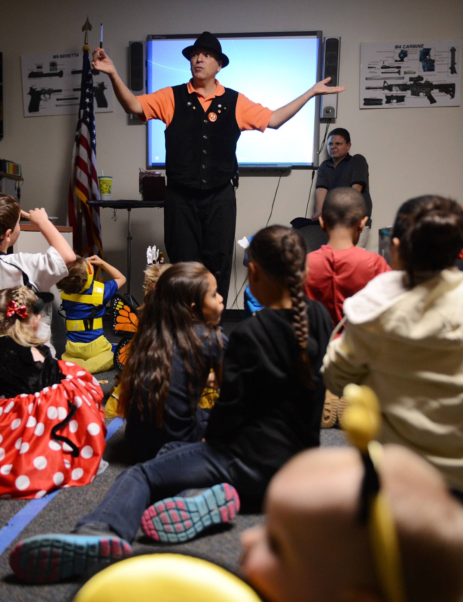 Richard Soos, 20th Security Forces Squadron pass and registration manager performs magic tricks for children of 20th SFS members during their second annual Howling Halloween party, Shaw Air Force Base, S.C., Oct. 25, 2013. Defenders from the 20th SFS and their children gathered  to participate in games and activities, a magic show, a haunted room, and a children’s costume contest. (U.S. Air Force photo by Senior Airman Tabatha Zarrella/Released)