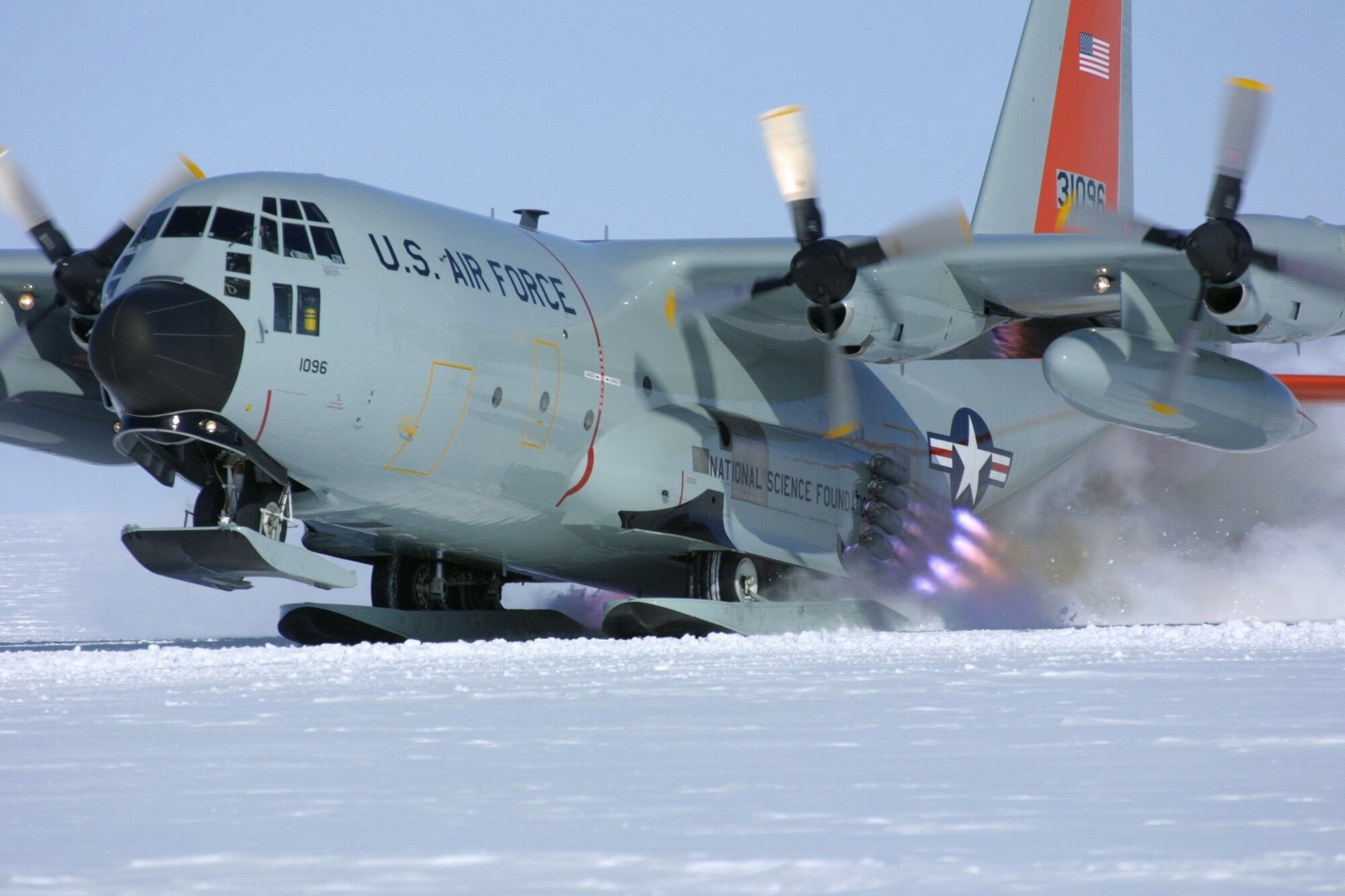CAMP SUMMIT, Greenland -- Air National Guard aircrew members utilize a jet-assisted takeoff from Camp Summit in April 2003. The ski-equipped LC-130 Hercules is assigned to the New York Air National Guard's 109th Airlift Wing. JATO provides a few extra knots of speed to pull the aircraft's nose up from skiways on the Greenland ice sheet. (Courtesy photo by Dr. Todd Valentic)