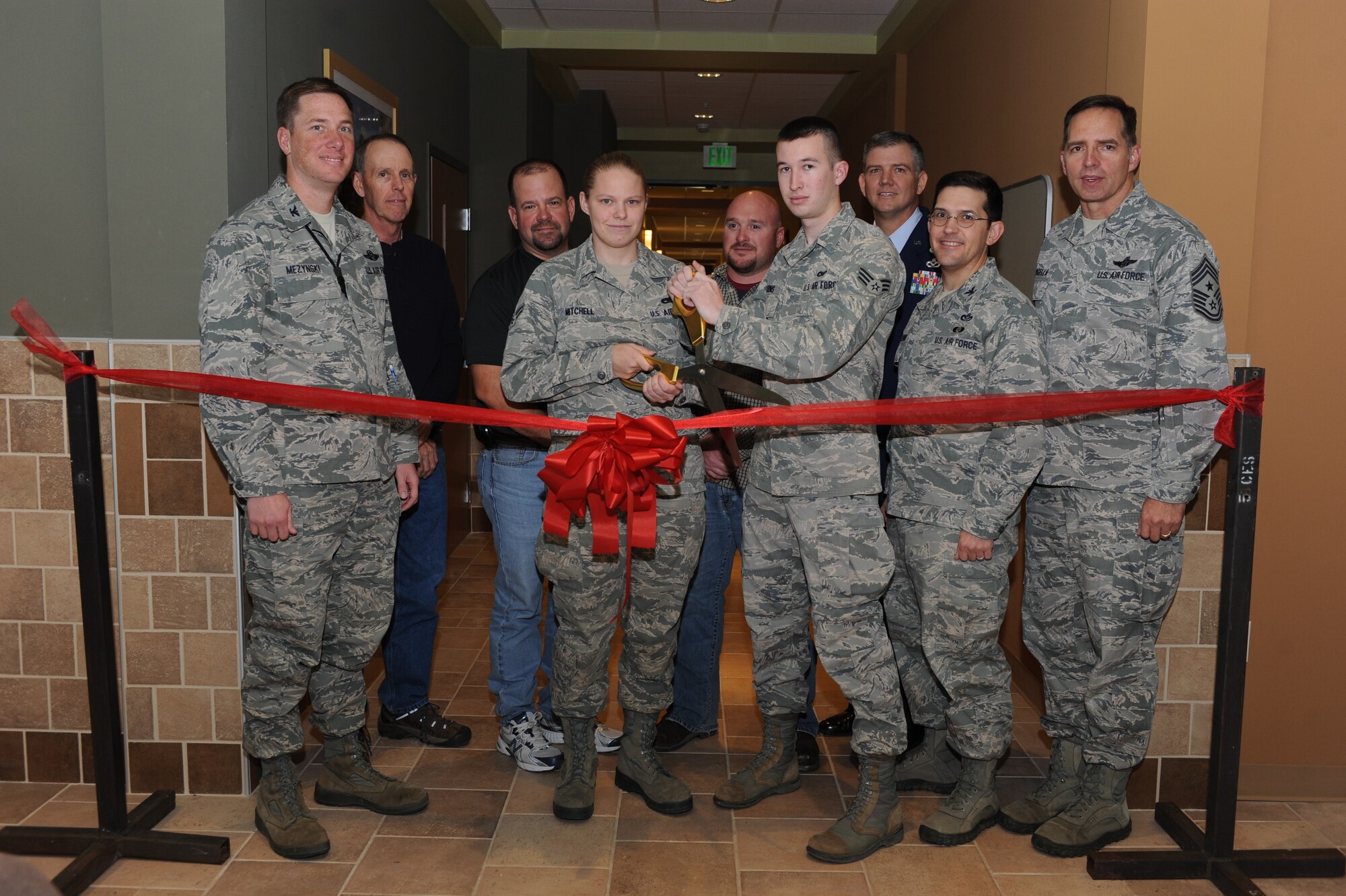 The newest Dormitory on base, Dorm 214, opened its doors to more than 160 Airmen assigned to Minot Air Force Base, N.D., Oct. 23. Base leadership joined Airmen and other guests in the unveiling of the new dorm during a ribbon cutting ceremony. (U.S. Air Force photo/Senior Airman Stephanie Sauberan)