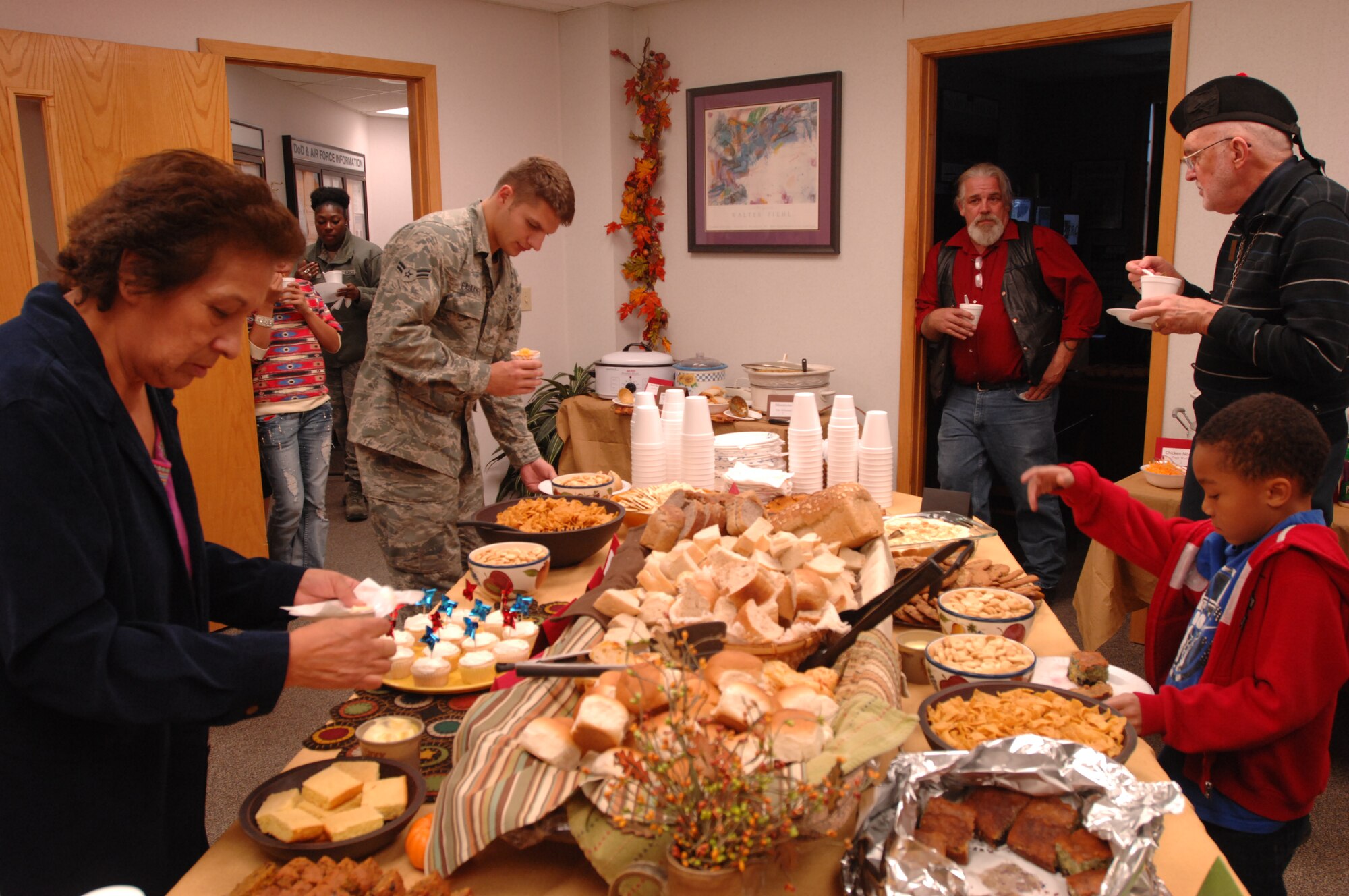 Guests dish up soups, stews and more at the Airman & Family Readiness Center's Seventh Annual Soup Supper, Oct. 24, 2013, on Grand Forks Air Force Base, N.D. At its inception, the Soup Supper was held in November as a precursor to Thanksgiving, but due to inclement weather, was moved back to October. (U.S. Air Force photo/Staff Sgt. Susan L. Davis)