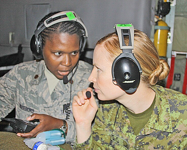 Maj. Julie Roseboro (left) poses a question to her instructor, Capt. JoAnne Schmid, of the Canadian Army, during the most recently conducted Critical Care Air Transport Team Basic Course at the U.S. Air Force School of Aerospace Medicine. Schmid served as an instructor as part of an international "Interfly" agreement signed last year.