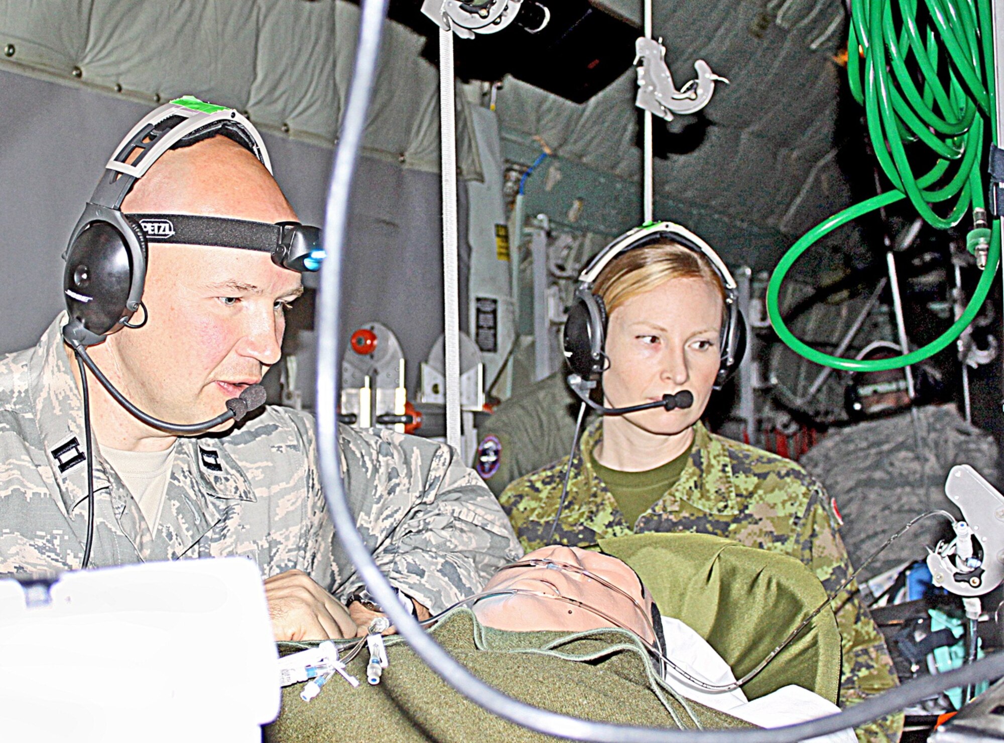 Capt. JoAnne Schmid, of the Canadian Army (right) serves as a Critical Care Air Transport Team Basic Course instructor, due to an agreement signed last year by the United States, Australia, Canada and Great Britain.