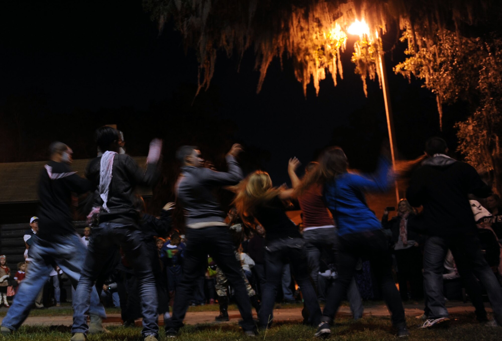 Keesler Airmen perform a “flash mob” dance to Michael Jackson’s Thriller during the Ghouls in the Park event at the marina park Oct. 25, 2013, Keesler Air Force Base, Miss. Technical training student Airmen and those awaiting further instruction in the 81st Training Group volunteered as “ghouls” to roam around, direct attendees and lead a flash mob at the end of the night to Michael Jackson’s Thriller. (U.S. Air Force photo by Airman 1st Class Stephan Coleman)