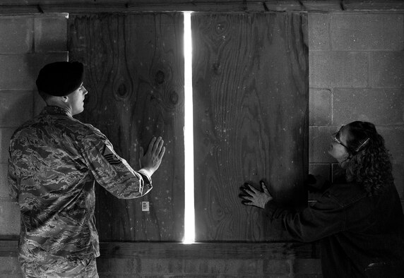 Base personnel close off opening to their room during a scenario during an active shooter training course held at Eglin Air Force Base, Fla., Oct. 28.  People from Eglin, Duke Field and Naval Air Station Pensacola attended the course to learn how to prepare their work environments in the event of an active shooter situation.  (U.S. Air Force photo/Samuel King Jr.)