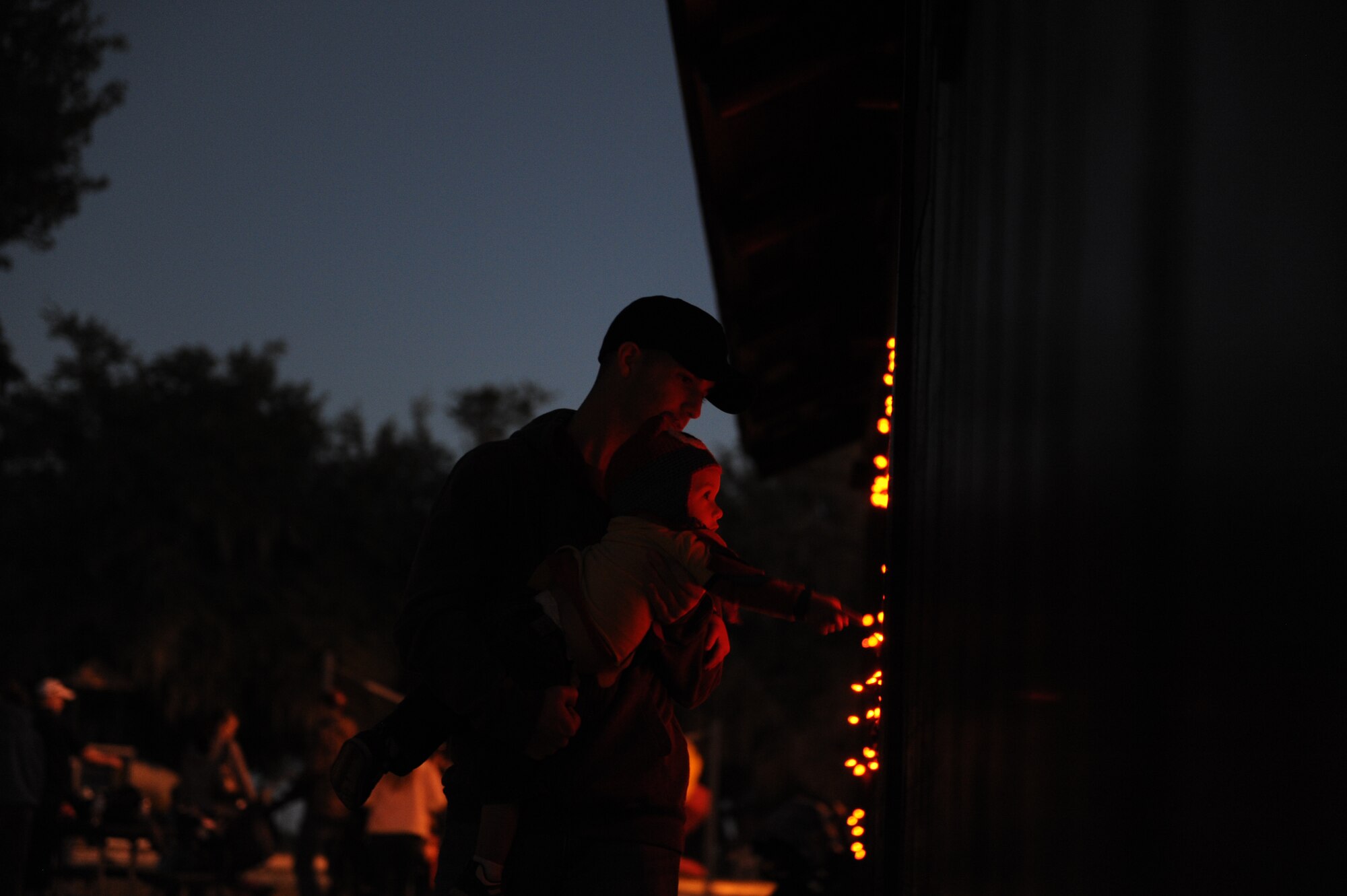 Staff Sgt. Brian Thompson, 335th Training Squadron, and daughter explore the Ghouls in the Park event at the marina park Oct. 25, 2013, Keesler Air Force Base, Miss. Various sponsors and private organizations from the base provided support and entertainment for the event, including “Trunk or Treat” by the Keesler Spouses Club, a haunted house by the Airman’s Council, and free popcorn provided by Keesler Federal Credit Union. (U.S. Air Force photo by Airman 1st Class Stephan Coleman)