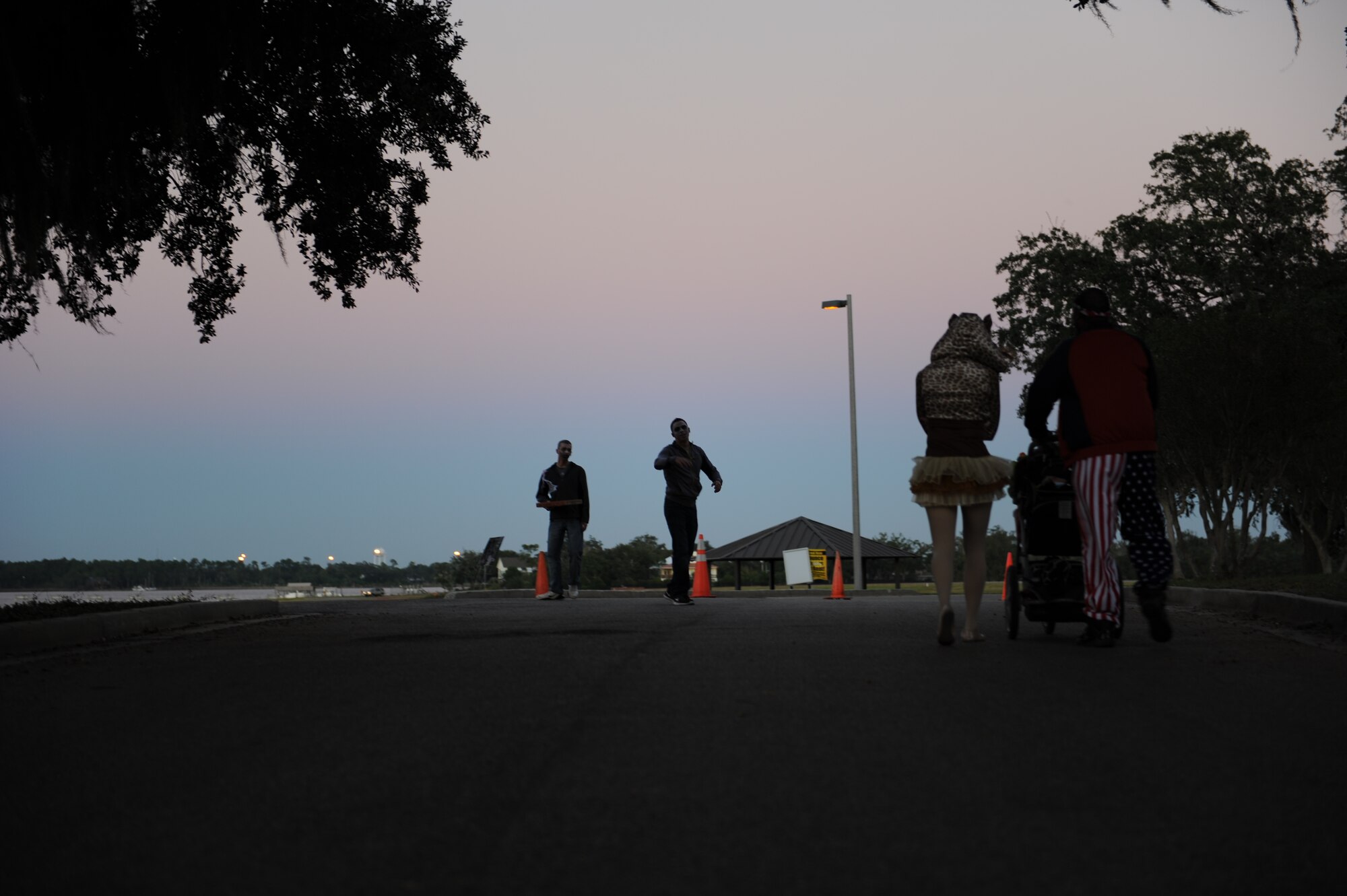 Airman Even Ryan and Airman Basic Bobby Ellis, 338th Training Squadron students, roam the marina park as zombies during the Ghouls in the Park event at the marina park Oct. 25, 2013, Keesler Air Force Base, Miss. Technical training student Airmen and those awaiting further instruction in the 81st Training Group volunteered as “ghouls” to roam around, direct attendees and lead a flash mob at the end of the night to Michael Jackson’s Thriller. (U.S. Air Force photo by Airman 1st Class Stephan Coleman)