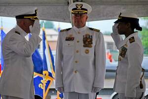 U.S. Coast Guard Cmdr. Michelle R. Watson, right, assumes command of Port Security Unit 305 from Cmdr. Michael J. Ferullo, left, as Capt. Karl S. Leonard, Coast Guard Reserve Unit Joint Staff South commanding officer, center, presides over a change of command ceremony at Fort Eustis, Oct. 19. Watson assumed command of PSU 305 after serving as the unit's executive officer. The unit's mission is to provide port security in support of military or humanitarian operations worldwide. During Ferullo’s tenure, PSU 305 deployed to the Middle East in support of Operation Enduring Freedom, where it provided seaward security at strategic port locations around the North Arabian Gulf, ensuring the free flow of personnel, equipment and commerce in the region.