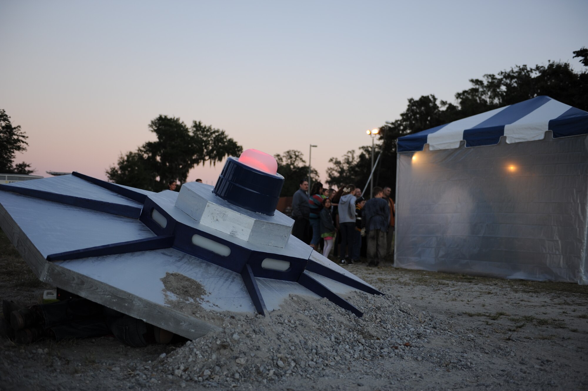 Keesler families discover an alien crash site at the Ghouls in the Park event at the marina park Oct. 25, 2013, Keesler Air Force Base, Miss. Various sponsors and private organizations from the base provided support and entertainment for the event, including “Trunk or Treat” by the Keesler Spouses Club, a haunted house by the Airman’s Council, and free popcorn provided by Keesler Federal Credit Union. (U.S. Air Force photo by Airman 1st Class Stephan Coleman)