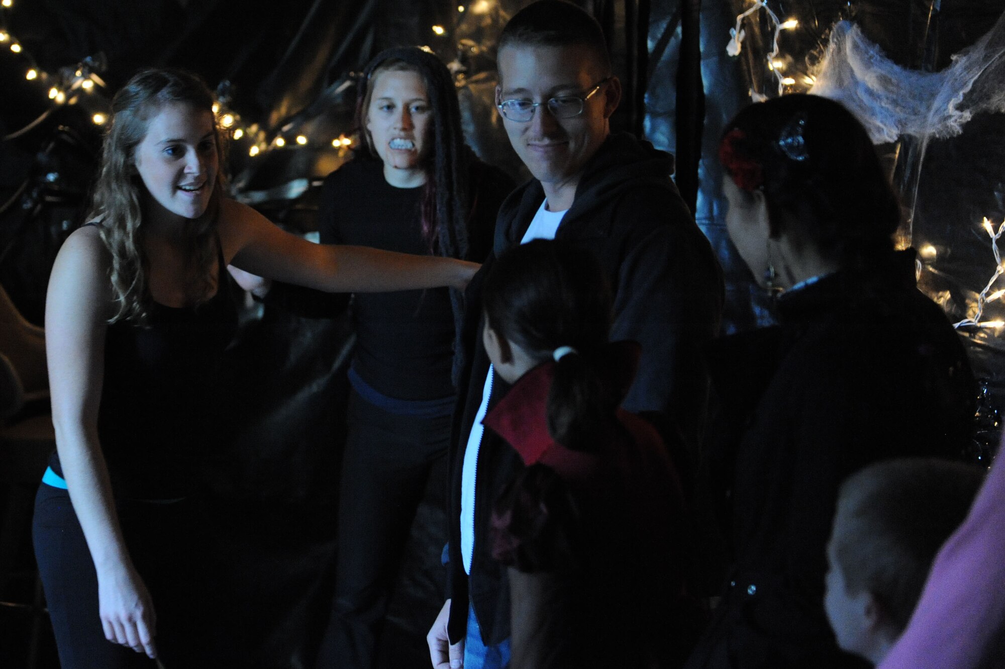 Airman 1st Class Mikayla Dunne, 81st Dental Squadron, warns a tour group of the “dangers” ahead in the Airman’s Council haunted house for the Ghouls in the Park event at the marina park Oct. 25, 2013, Keesler Air Force Base, Miss. The Airman’s Council provided an array of volunteers who lead tours, guided patrons, and dressed as monsters for the event. (U.S. Air Force photo by Airman 1st Class Stephan Coleman)