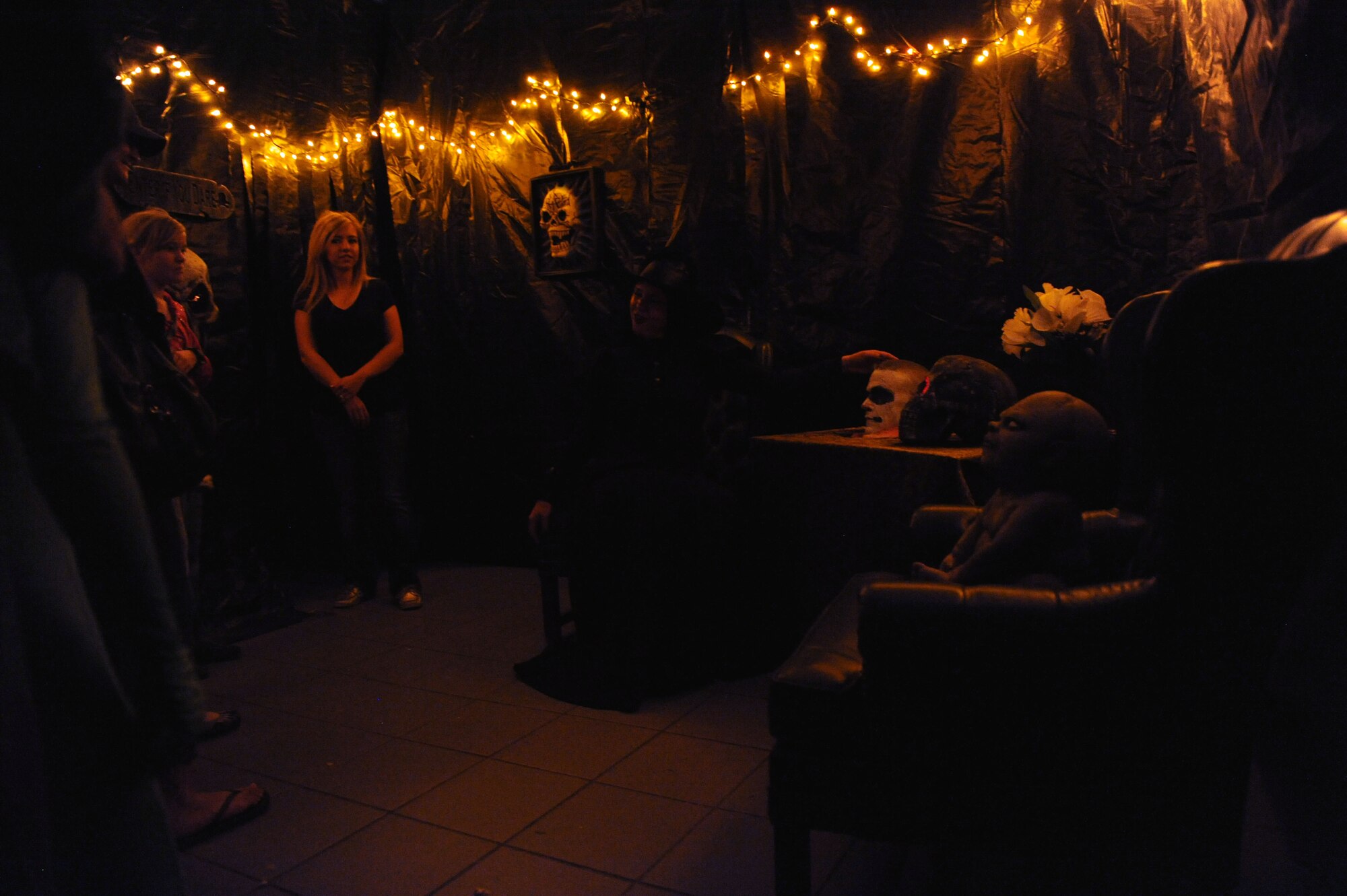 Second Lt. Jackie Stammen, 335th Training Squadron student, leads a tour through the Airman’s Council haunted house for the Ghouls in the Park event at the marina park Oct. 25, 2013, Keesler Air Force Base, Miss. The Airman’s Council provided an array of volunteers who lead tours, guided patrons, and dressed as monsters for the event. (U.S. Air Force photo by Airman 1st Class Stephan Coleman)