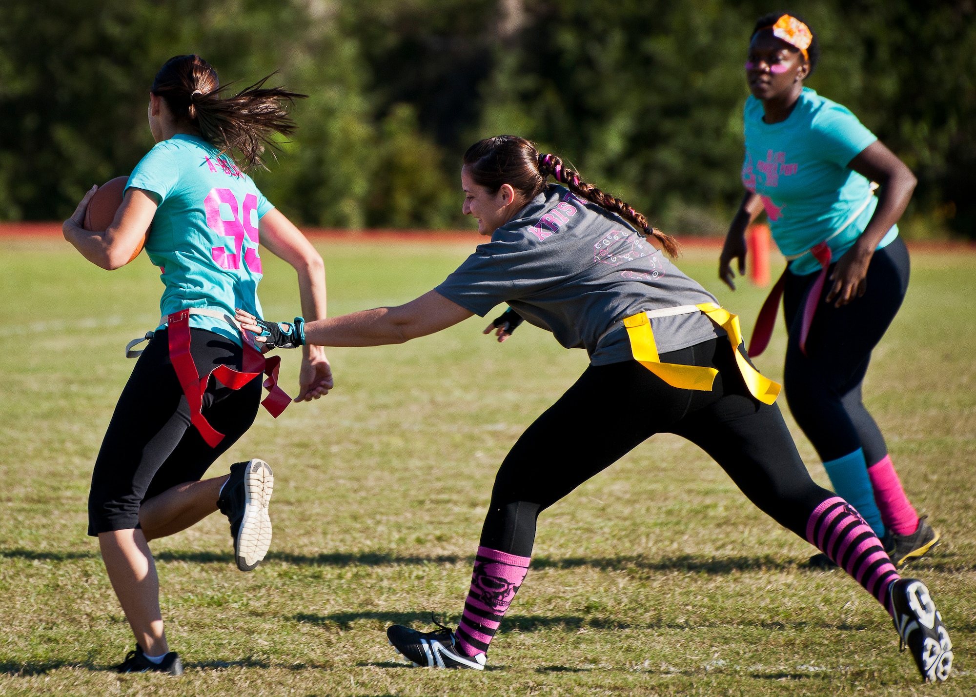 The 96th Logistics Readiness Squadron team’s quarterback darts for some extra yardage during their powderpuff football game against the 96th Force Support Squadron Oct. 25 at Eglin Air Force Base, Fla. LRS won the game 20-18. (U.S. Air Force photo/Samuel King Jr.)
