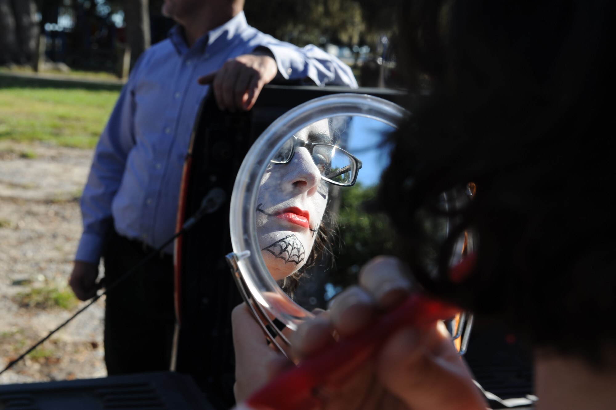 Airman Basic Shelby Smith, 338th Training Squadron student, applies make up for the Ghouls in the Park event at the marina park Oct. 25, 2013, Keesler Air Force Base, Miss. Technical training student Airmen and those awaiting further instruction in the 81st Training Group volunteered as “ghouls” to roam around, direct attendees and lead a flash mob at the end of the night to Michael Jackson’s Thriller. (U.S. Air Force photo by Airman 1st Class Stephan Coleman)