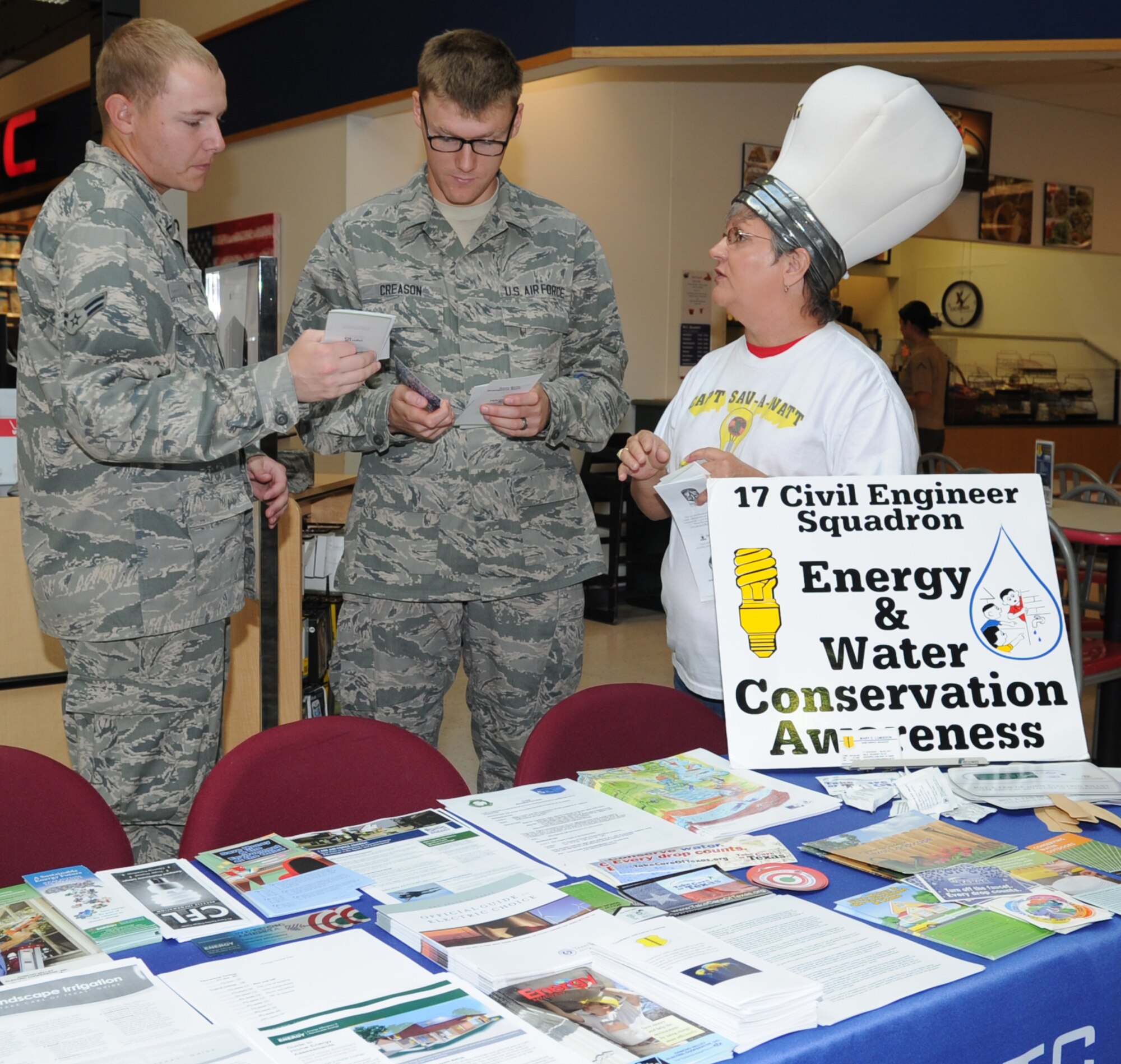 GOODFELLOW AIR FORCE BASE, Texas -- Mary Lumsdon, 17th Civil Engineer Squadron base energy manager, talks to Airmen about energy conservation at the Exchange Oct. 25. Other events during the month included passing out flyers at the gates and talking to children at the School Age Program. (U.S. Air Force photo/ Staff Sgt. Laura R. McFarlane)