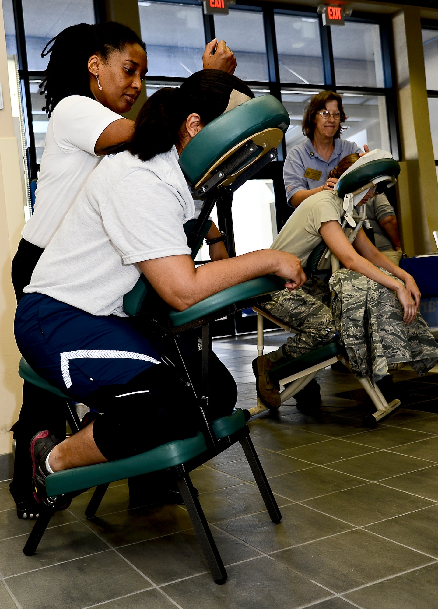 Members from the 6th Air Mobility Wing receive chair massages during the first annual Caring Hands Support Our Troops event at the Health and Wellness Center on MacDill Air Force Base, Fla., Oct. 25, 2013. The Caring Hands event was organized as a way to educate military members and their spouses on the different massage therapy options, and the physical and mental health advantages that are associated with each. (U.S. Air Force photo by Senior Airman Melanie Bulow-Kelly/Released)
