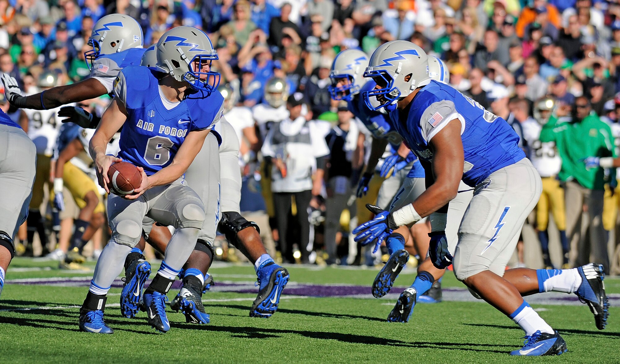 Air Force freshman quarterback Nate Romine fakes a handoff during the Air Force-Notre Dame match at Falcon Stadium Oct. 26, 2013. The Falcons fell to the Fighting Irish, 45-10. The game marked Nate Romine's first start as quarterback. (U.S. Air Force photo/Mark Watkins)