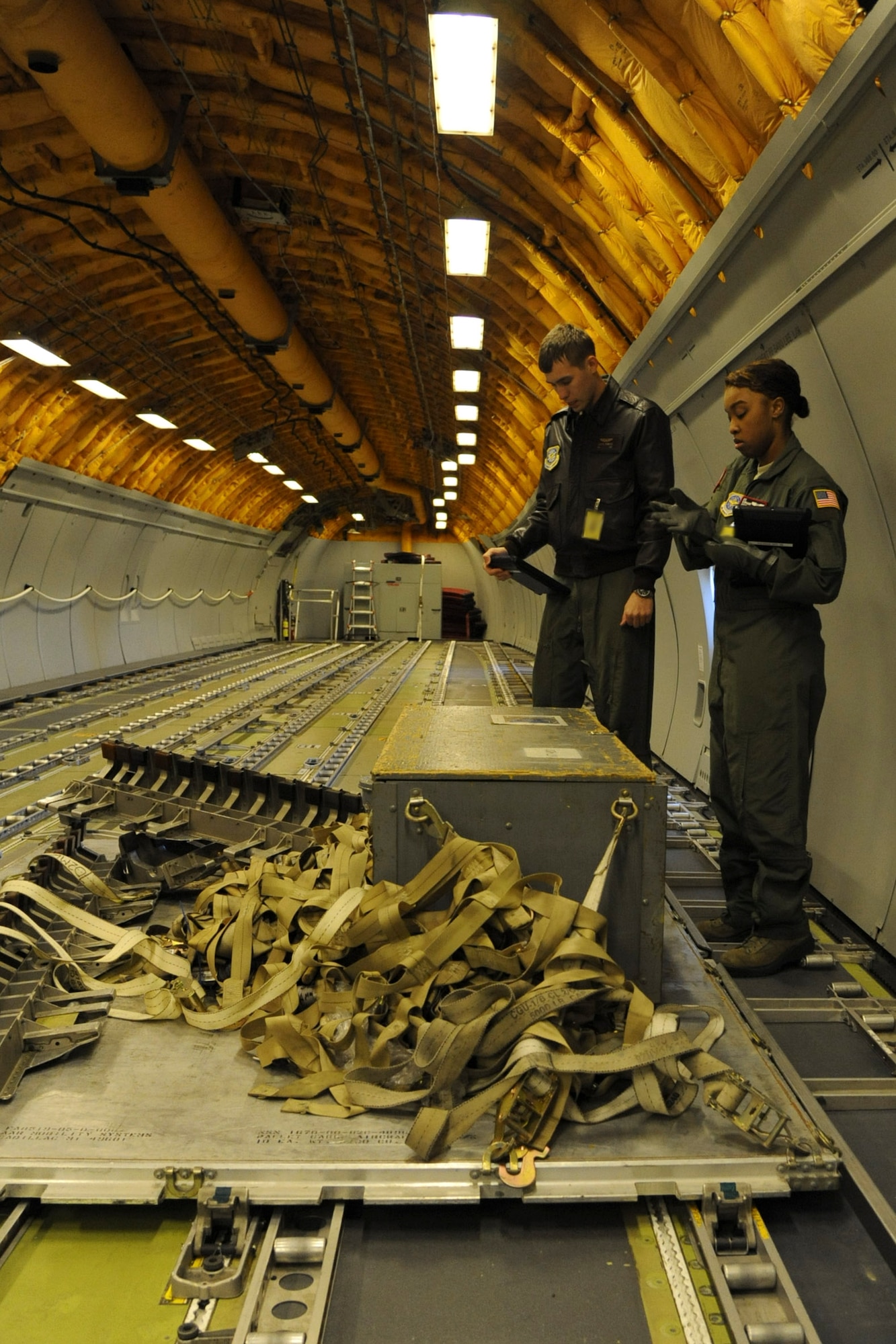 Airman 1st Class Stephanie Hodge, 2nd Air Refueling Squadron student boom operator, practices calculations on a disassembled pallet Oct. 21, 2013, at Joint Base McGuire-Dix-Lakehurst, N.J. Hodge practiced calculations before beginning a static load to further develop her skills as a boom operator during cargo phase, the last phase of local boom operator training. (U.S. Air Force photo by Airman 1st Class Sean M. Crowe/Released)