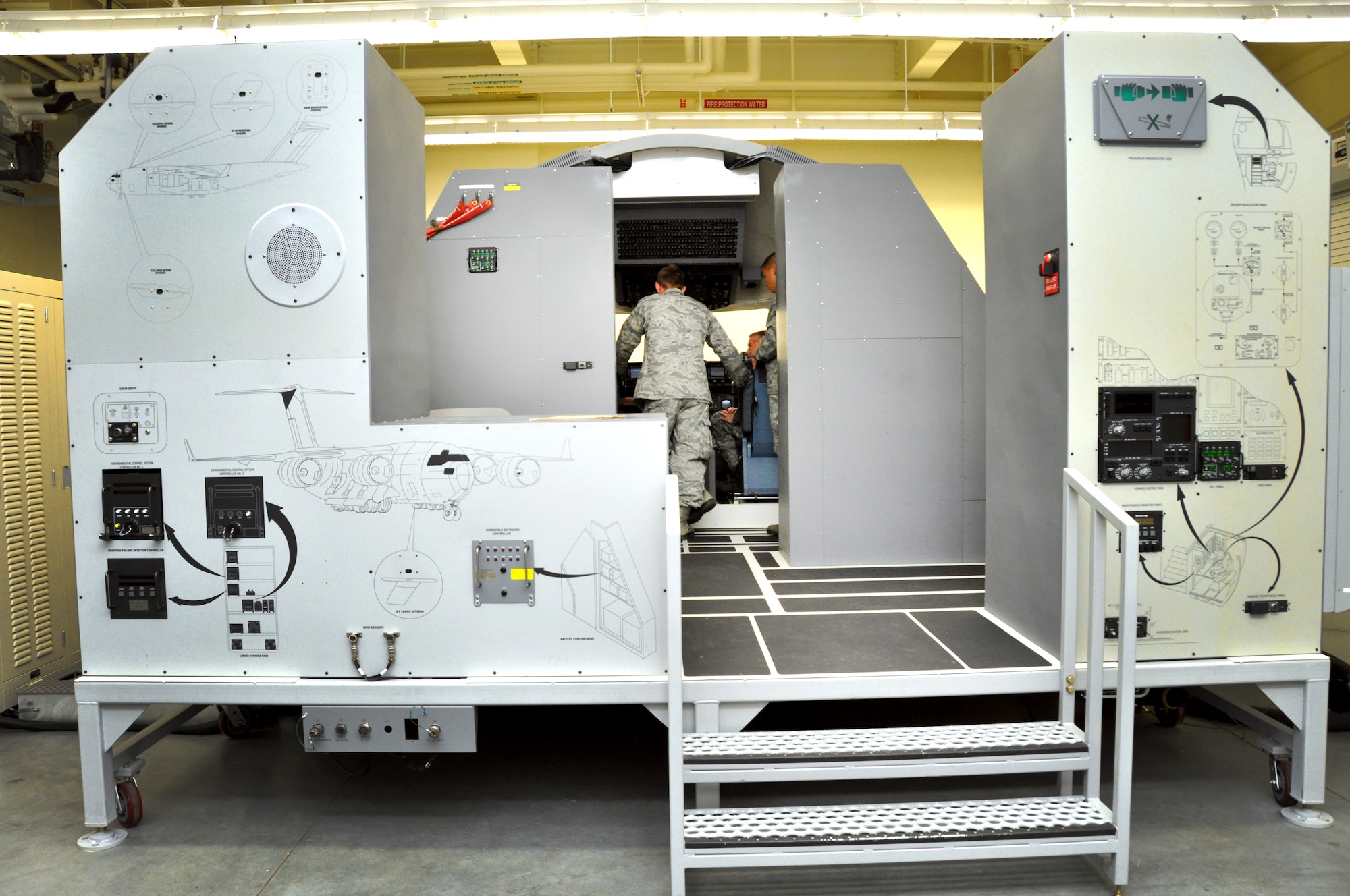 60th Maintenance Group communication/navigation systems specialists train in the Training Evaluation Performance Aircraft Training Set Oct. 18 in the 373rd TRS Det 14 C-17 training facility. (U.S. Air Force photo/Staff Sgt. Patrick Harrower)