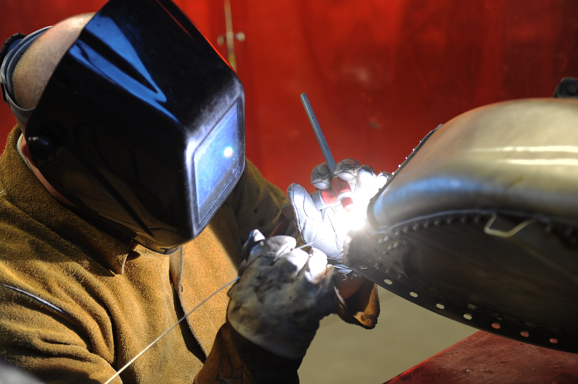 Airman 1st Class Joshua Crawford, 5th Maintenance Squadron aircraft metal technology apprentice, works on welding together parts of an engine cover, Oct. 24. Crawford is part of a dedicated team of metals technicians here. (U.S. Air Force photo/Airman 1st Class Lauren Pitts)