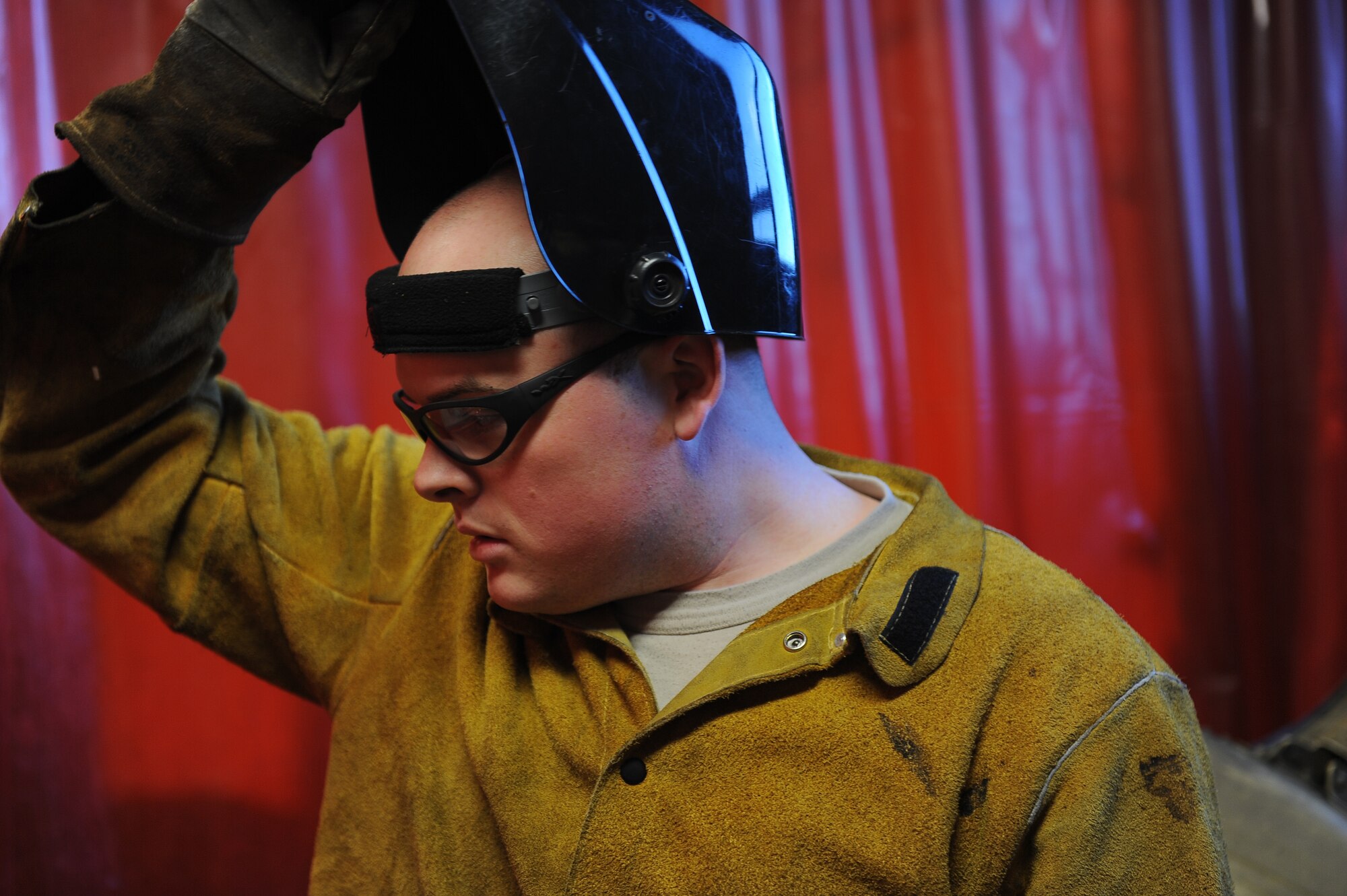 Airman 1st Class Joshua Crawford, 5th Maintenance Squadron aircraft metal technology apprentice, removes his protective face gear after welding rivets on parts of an engine cover, Oct. 24. Originally from Macon, Ga., Crawford is a metals technician with the 5th MXS welding section here. (U.S. Air Force photo/Airman 1st Class Lauren Pitts)