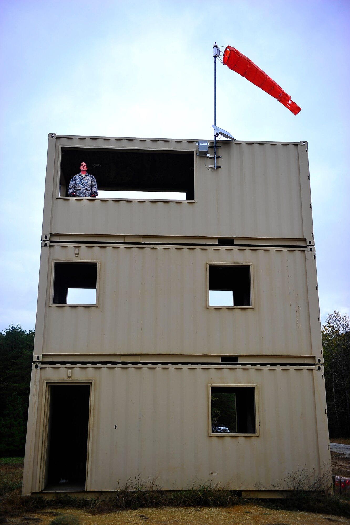 FORT A.P. HILL, Va. – An 817th Contingency Response Group Airman waits on the third floor of a training tower for an aircraft to land during an exercise here Oct. 23. The 817 CRG training focused on airfield operations, which included training for an assessment team, landing zone safety officers, and other unit type code training objectives. (U.S. Air Force photo by Staff Sgt. Gustavo Gonzalez)