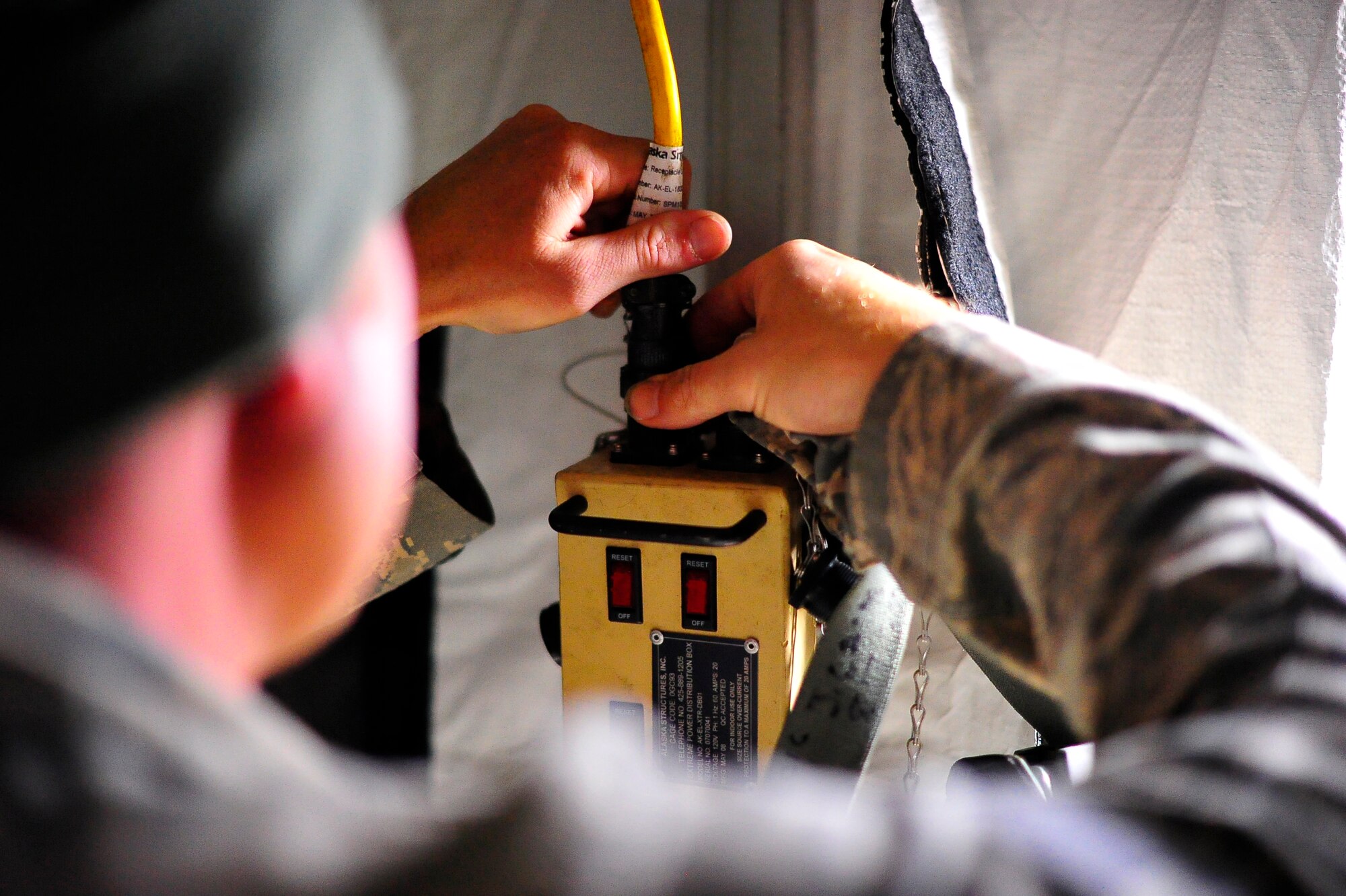 Fort A.P. HILL, Va. – An 817th Contingency Response Group Airman sets up electrical wires inside a tent during an exercise here Oct. 22. The 817 CRG training focused on airfield operations, which included training for the assessment team, landing zone safety officer, and other unit type code training objectives. (U.S. Air Force photo by Staff Sgt. Gustavo Gonzalez)