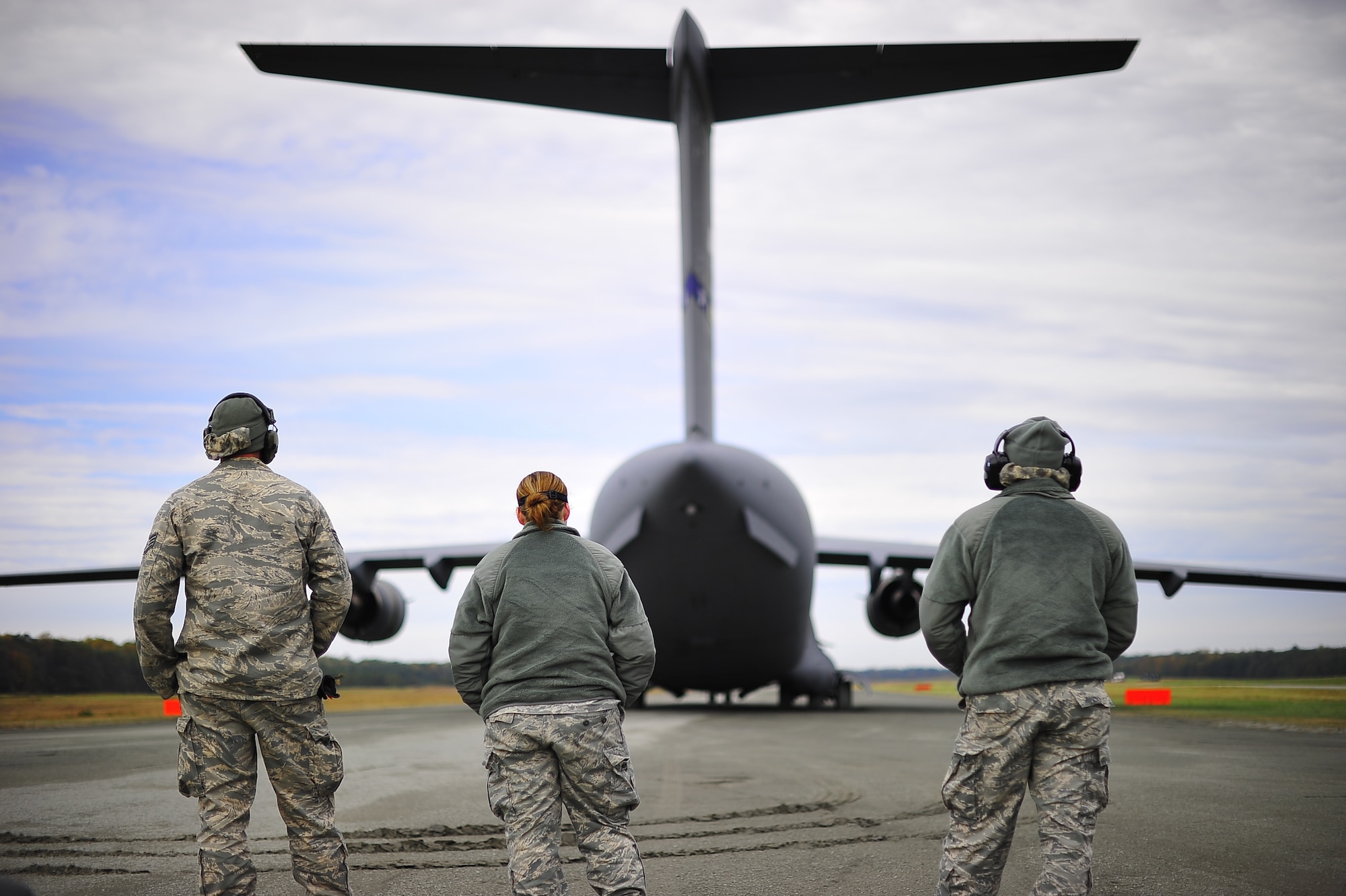 FORT A.P. HILL, Va. – Three 817th Contingency Response Group Airmen wait to be cleared to board a U.S. Air Force C-17 Globemaster III assigned to Joint Base McGuire-Dix-Lakehurst, N.J., during an exercise here Oct. 22. The 817 CRG training focused on airfield operations, which included training for the assessment team, landing zone safety officer, and other unit type code training objectives. (U.S. Air Force photo by Staff Sgt. Gustavo Gonzalez)