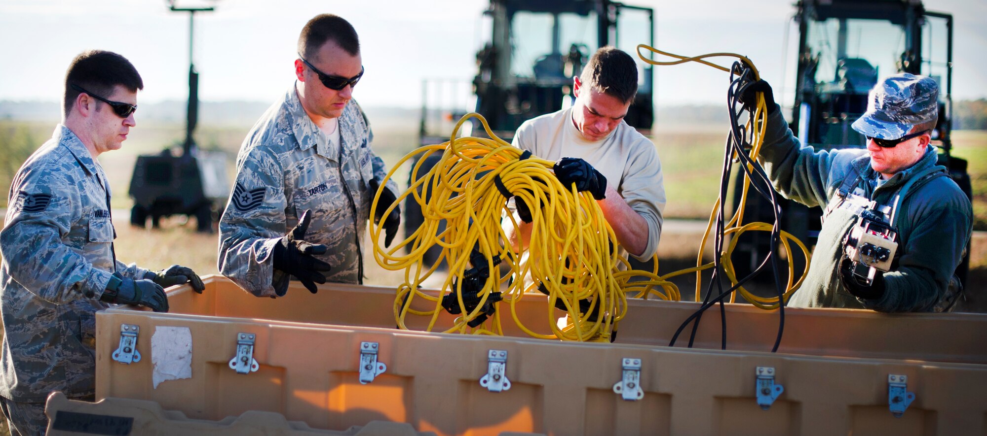 FORT A.P. HILL, Va. – Members of the 817th Contingency Response Group grab tent equipment to set up during an exercise here Oct. 22. The 817 CRG training focused on airfield operations, which included training for the assessment team, landing zone safety officer, and other unit type code training objectives. (U.S. Air Force photo by Staff Sgt. Gustavo Gonzalez)