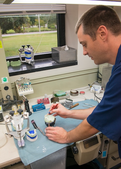 U.S. Air Force Tech. Sgt. Matthew Fitzgerald, 23d Aerospace Medicine Squadron dental lab NCO in charge, works with a diagnostic cast to shape a retainer at Moody Air Force Base, Ga., Sept. 30, 2013. Dental lab technicians can produce complete dental appliances in six to eight hours. (U.S. Air Force photo by Airman 1st Class Ryan Callaghan/Released)
