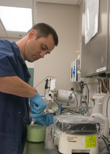 U.S. Air Force Tech. Sgt. Matthew Fitzgerald, 23d Aerospace Medicine Squadron dental lab NCO in charge, creates a cast of a patient’s teeth at Moody Air Force Base, Ga., Sept. 30, 2013. Fitzgerald used a quick-set powder mixture to create stone casts, which are used for molding retainers, crowns and night guards. (U.S. Air Force photo by Airman 1st Class Ryan Callaghan/Released)
