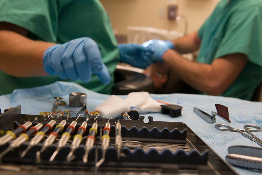 Monica Riddle, 23d Aerospace Medicine Squadron dental assistant, reaches for a tool at Moody Air Force Base, Ga., Sept. 30, 2013. Dental assistants sanitize, wrap and label tool sets after each patient. (U.S. Air Force photo by Airman 1st Class Ryan Callaghan/Released)
