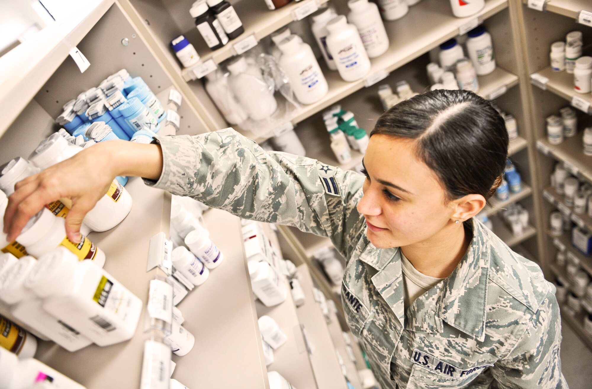 U.S. Air Force Airman 1st Class Julianna Ferrante, 7th Medical Support Squadron pharmacy technician, reaches for a prescription at the Dyess pharmacy, Oct. 22, 2013, at Dyess Air Force Base, Texas.  The pharmacy houses more than 1,000 different medications including eye drops, creams, ointments and insulin. (U.S. Air Force photo by Airman 1st Class Kedesha Pennant/Released)