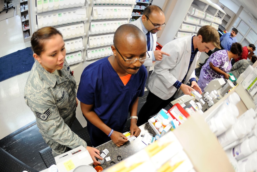 Dyess pharmacists and pharmacy technicians work together to fill orders and help customers, Oct. 21, 2013. Pharmacists and pharmacy technicians follow a nine-step checklist to ensure accuracy, which verifies patient and medical information. (U.S. Air Force photo by Airman 1st Class Kedesha Pennant/Released)


