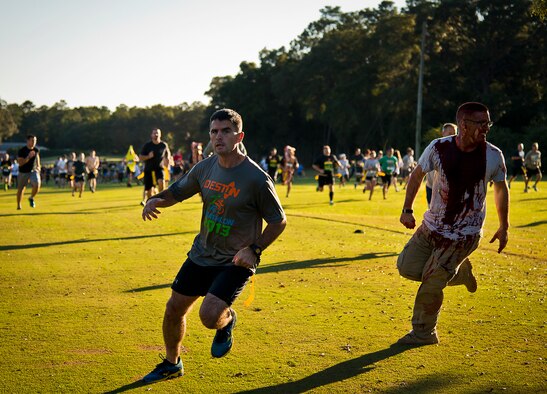 One of the first runners tries to escape a zombie attack at the beginning of the 2nd Annual Zombie Run Oct. 26 at the Eglin Air Force Base golf course.  More than 500 people attempted to outrun zombies and maneuver through various obstacles along the four-mile course.  (U.S. Air Force photo/Samuel King Jr.)