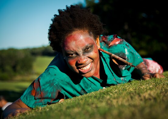 A zombie nurse crawls forward at the 2nd Annual Zombie Run Oct. 26 at the Eglin Air Force Base golf course.  More than 500 people attempted to outrun zombies and maneuver through various obstacles along the four-mile course.  (U.S. Air Force photo/Samuel King Jr.)