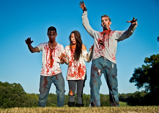 Bloody zombies move toward the runners at the 2nd Annual Zombie Run Oct. 26 at the Eglin Air Force Base golf course.  More than 500 people attempted to outrun zombies and maneuver through various obstacles along the four-mile course.  (U.S. Air Force photo/Samuel King Jr.)