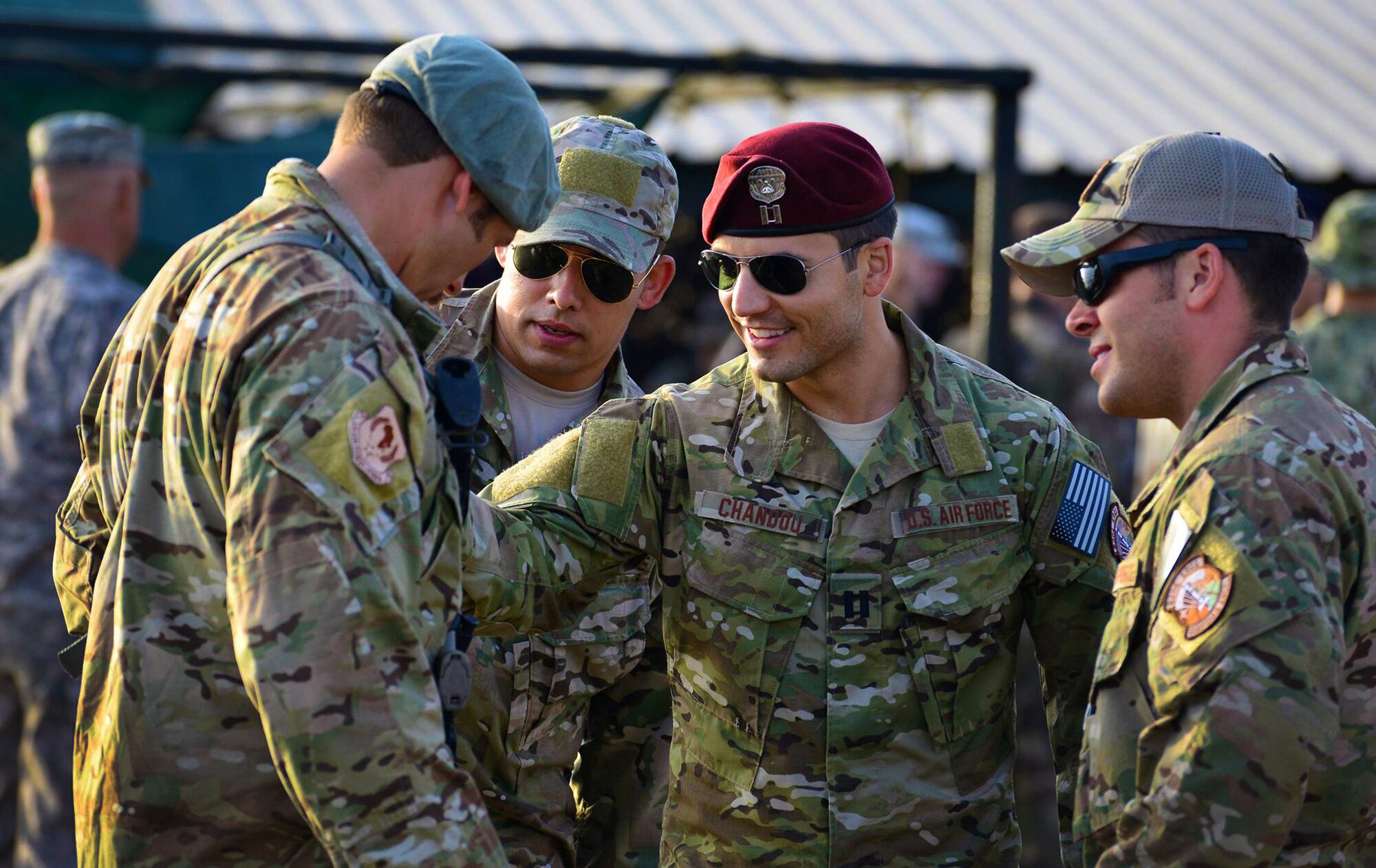 CAMP LEMONNIER, Djibouti -- U.S. Air Force Reservist Staff Sgt. Benjamin Domian, a SERE specialist with the 920th Rescue Wing was named honor graduate of the French Forces Desert Combat Survival Course held here in October. Sergeant Domian (left), is seen here showing French desert combat badge to fellow teammates (from left to right) Staff Sgt. Jonathon Schmitz, a SERE specialist with the 100th Air Refueling Wing, RAF Mildenhall, and from the 920th, Combat Rescue Officer Capt. Luc Chandou and pararescueman Senior Master Sgt. Joseph Traska, after a graduation ceremony here Oct. 16. More than 160 French and U.S. military members participated in the 10-day desert combat course, with about 143 completing the test of mental and physical obstacles in the Djiboutian desert. Joint training, such as this, builds relationships with partner nations and ensures Combined Joint Task Force-Horn of Africa members are continually ready to support military operations in East Africa to defeat violent extremist organizations. (U.S. Air Force photo by Tech. Sgt. Chad Thompson)