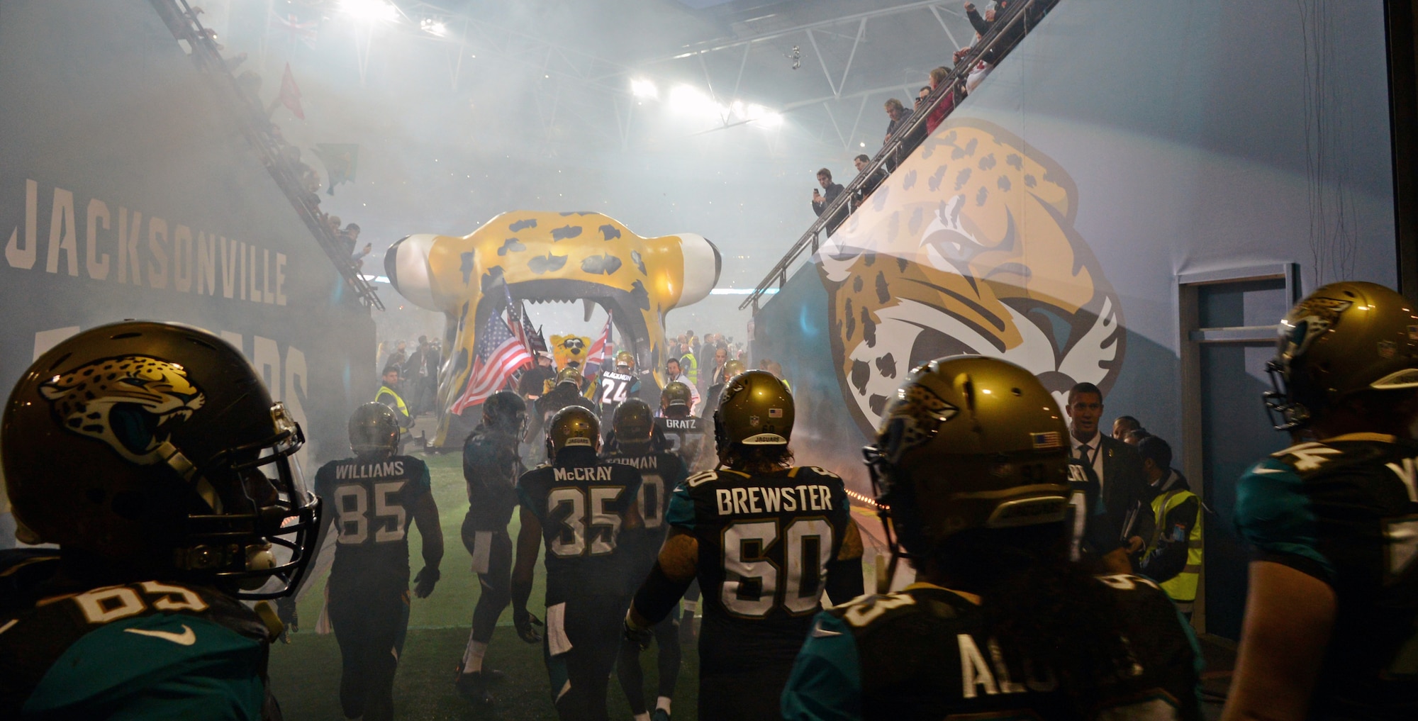 The National Football League’s Jacksonville Jaguars prepare to take the field Oct. 27, 2013, during the internationally televised game against the San Francisco 49ers at Wembley Stadium in London, England. At the front of the formation, U.S. Air Force Airman 1st Class James Taylor, 100th Security Forces Squadron patrolman, held the American flag and lead the charge onto the field. The NFL continues its Salute to Service campaign by giving Taylor and U.S. Air Force Airman Sara V. Summers, 48th Security Forces Squadron patrolman from RAF Lakenheath, the opportunity to lead rival football teams onto the field. (U.S. Air Force photo by Senior Airman Christine Griffiths/Released)