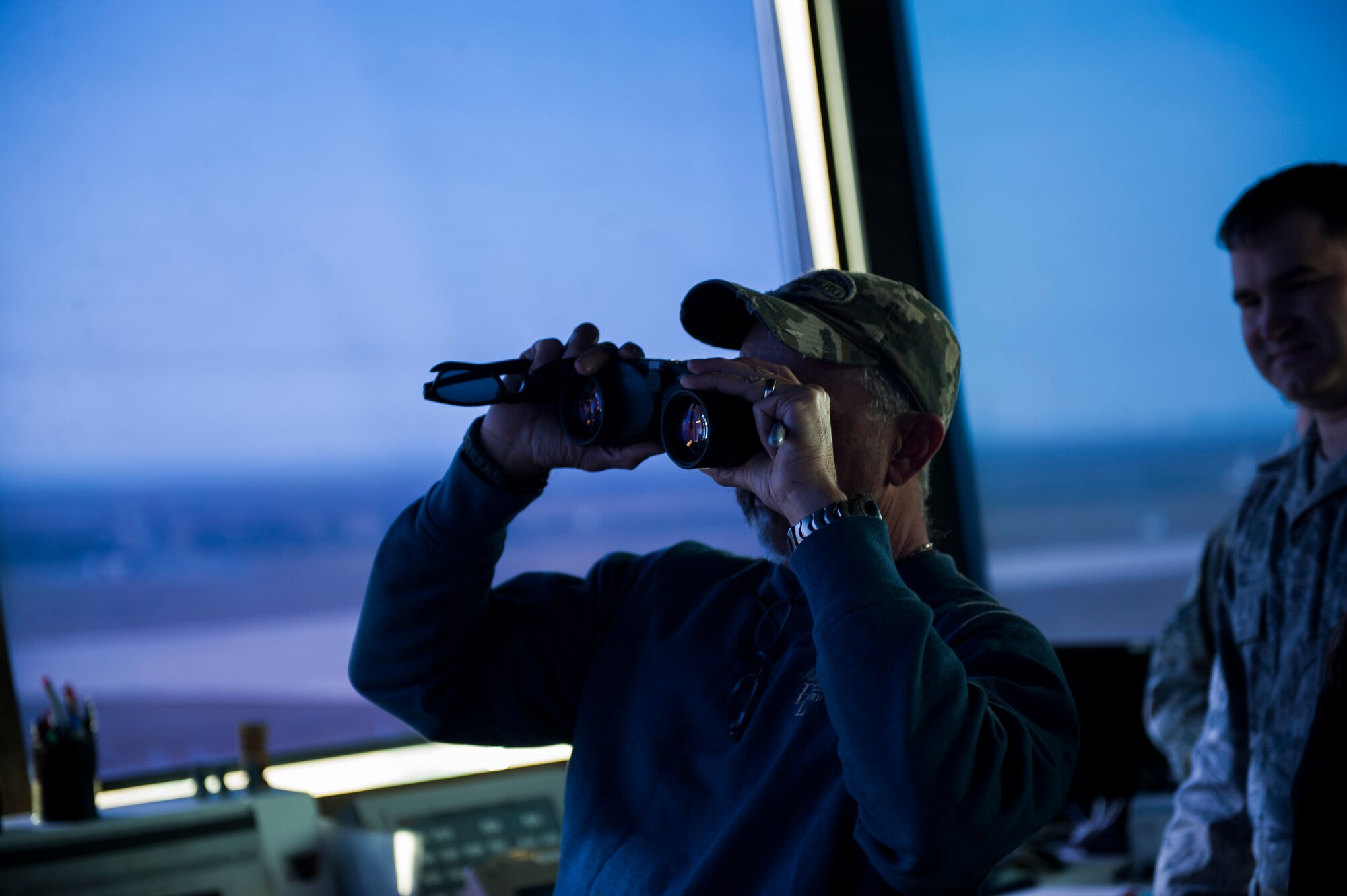 Country music artist Aaron Tippin views the flightline from the control tower during a tour at Kunsan Air Base, Republic of Korea, Oct. 25, 2013. Tippin performed at several military bases around Korea in a tour sponsored by Armed Forces Entertainment and Stars for Stripes. (U.S. Air Force photo by Senior Airman Clayton Lenhardt/Released)