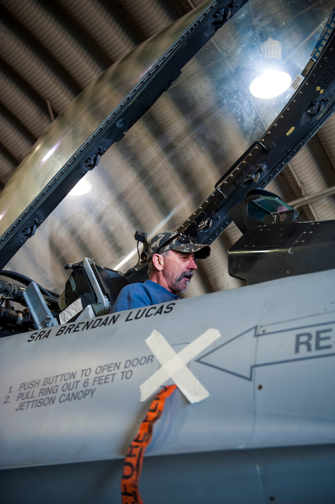 Country music artist Aaron Tippin sits in an F-16 during a tour at Kunsan Air Base, Republic of Korea, Oct. 25, 2013. Tippin performed at several military bases around Korea in a tour sponsored by Armed Forces Entertainment and Stars for Stripes. (U.S. Air Force photo by Senior Airman Clayton Lenhardt/Released)