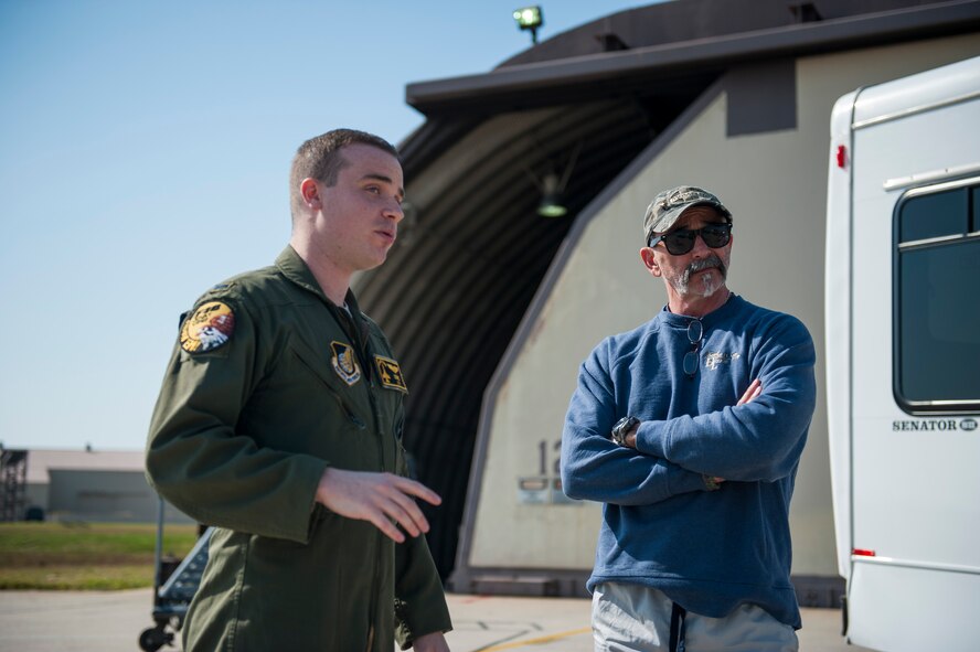 1st Lt. Ryan Mendenhall, 80th Fighter Squadron, discusses flying with country music artist Aaron Tippin during a tour at Kunsan Air Base, Republic of Korea, Oct. 25, 2013. Tippin performed at several military bases around Korea in a tour sponsored by Armed Forces Entertainment and Stars for Stripes. (U.S. Air Force photo by Senior Airman Clayton Lenhardt/Released)