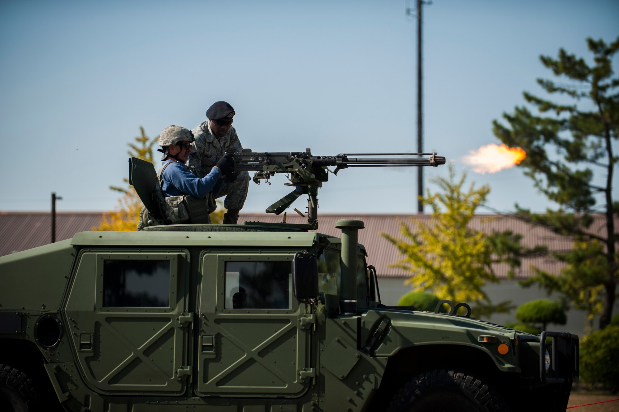 Country music artist Aaron Tippin fires an M-2 Browning Machine Gun during a demonstration at Kunsan Air Base, Republic of Korea, Oct. 25, 2013. Tippin performed at several military bases around Korea in a tour sponsored by Armed Forces Entertainment and Stars for Stripes. (U.S. Air Force photo by Senior Airman Clayton Lenhardt/Released)