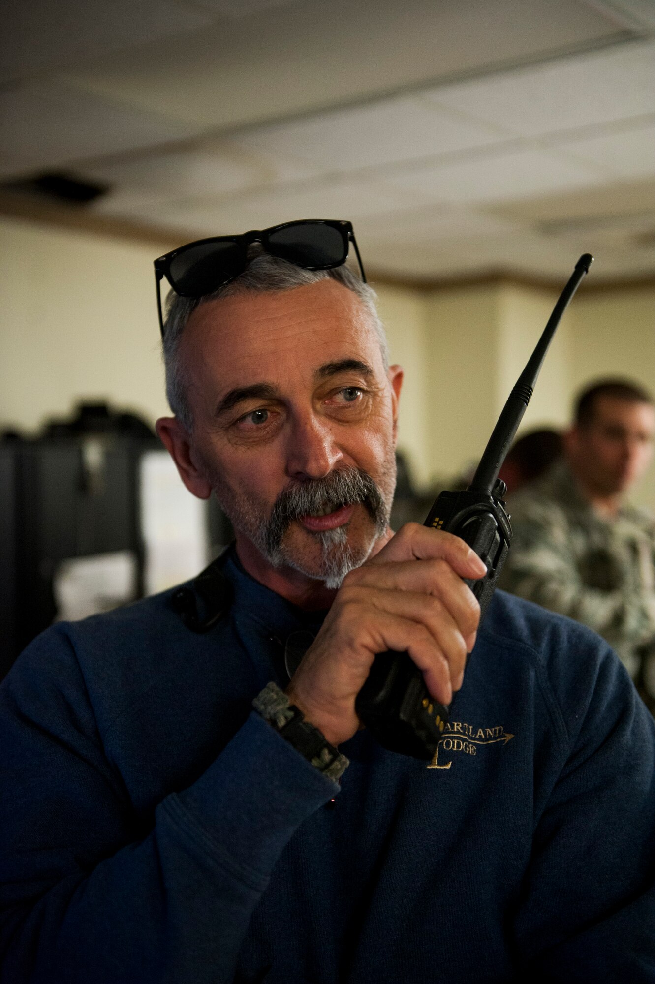 Country music artist Aaron Tippin speaks with all the 8th Security Forces Squadron Airmen on shift via radio while touring Kunsan Air Base, Republic of Korea, Oct. 25, 2013. Tippin performed at several military bases around Korea in a tour sponsored by Armed Forces Entertainment and Stars for Stripes. (U.S. Air Force photo by Senior Airman Clayton Lenhardt/Released)