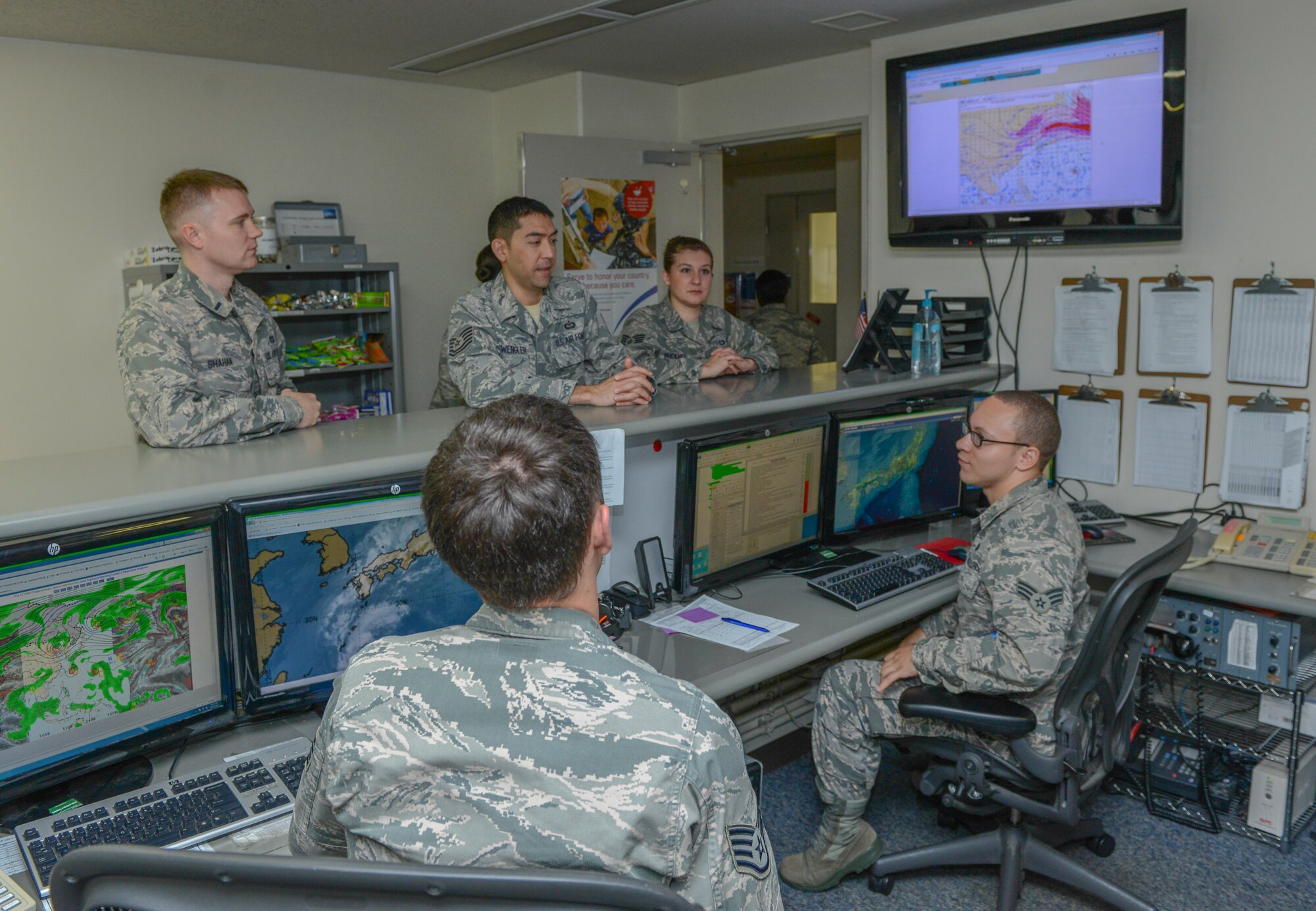 Airmen from the 374th Operational Support Squadron Weather Flight receive a meteorological conference at Yokota Air Base, Japan, Oct. 24, 2013. A METCON is a brief given to the entire weather flight on various weather conditions. This information ensures the team is all on the same page. (U.S. Air Force photo by Senior Airman Michael Washburn/Released) 
